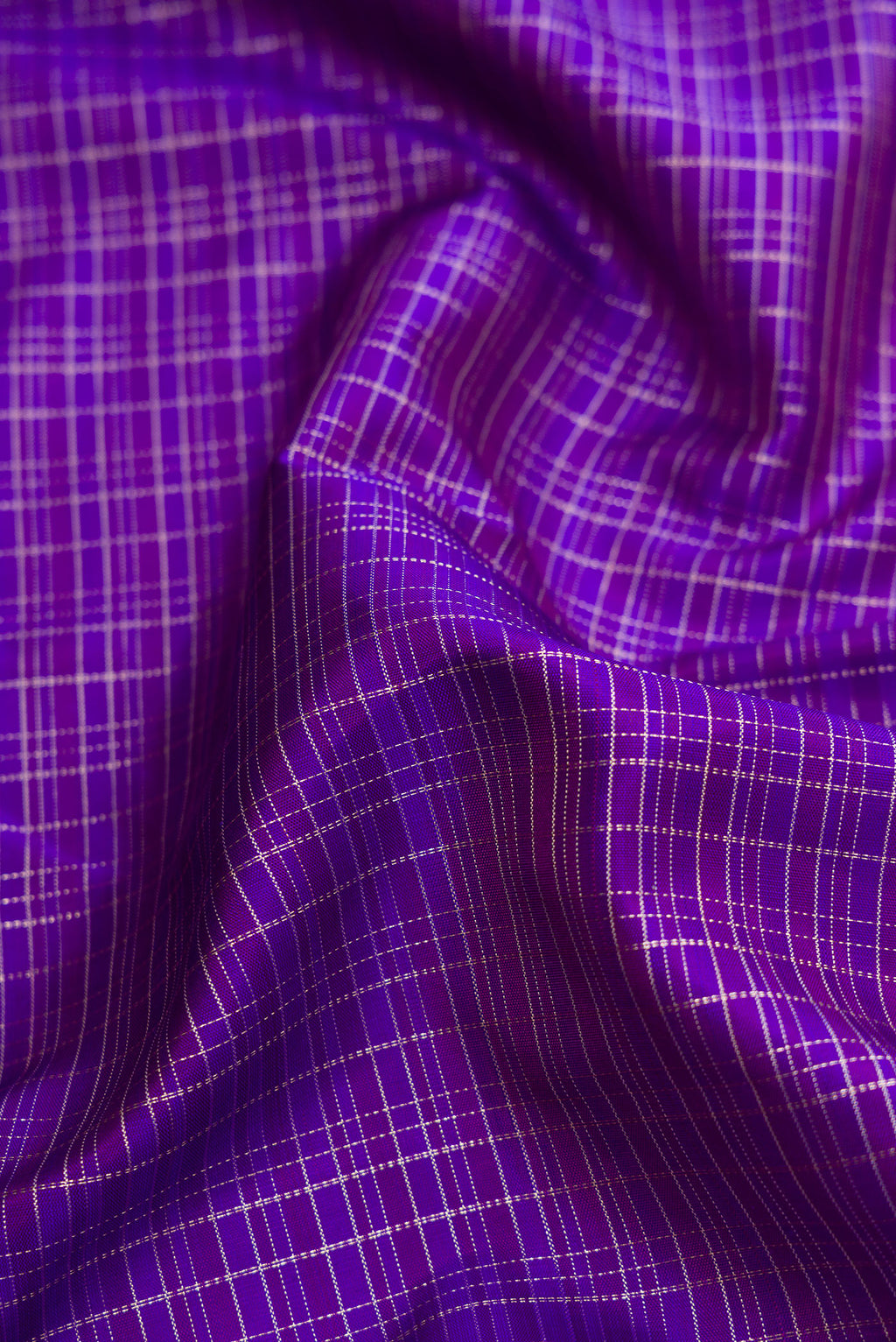 Close up of Royal Blue Dual Tone Kanchipuram Silk Saree with Checked design on the body and Zari Border.  displaying folds