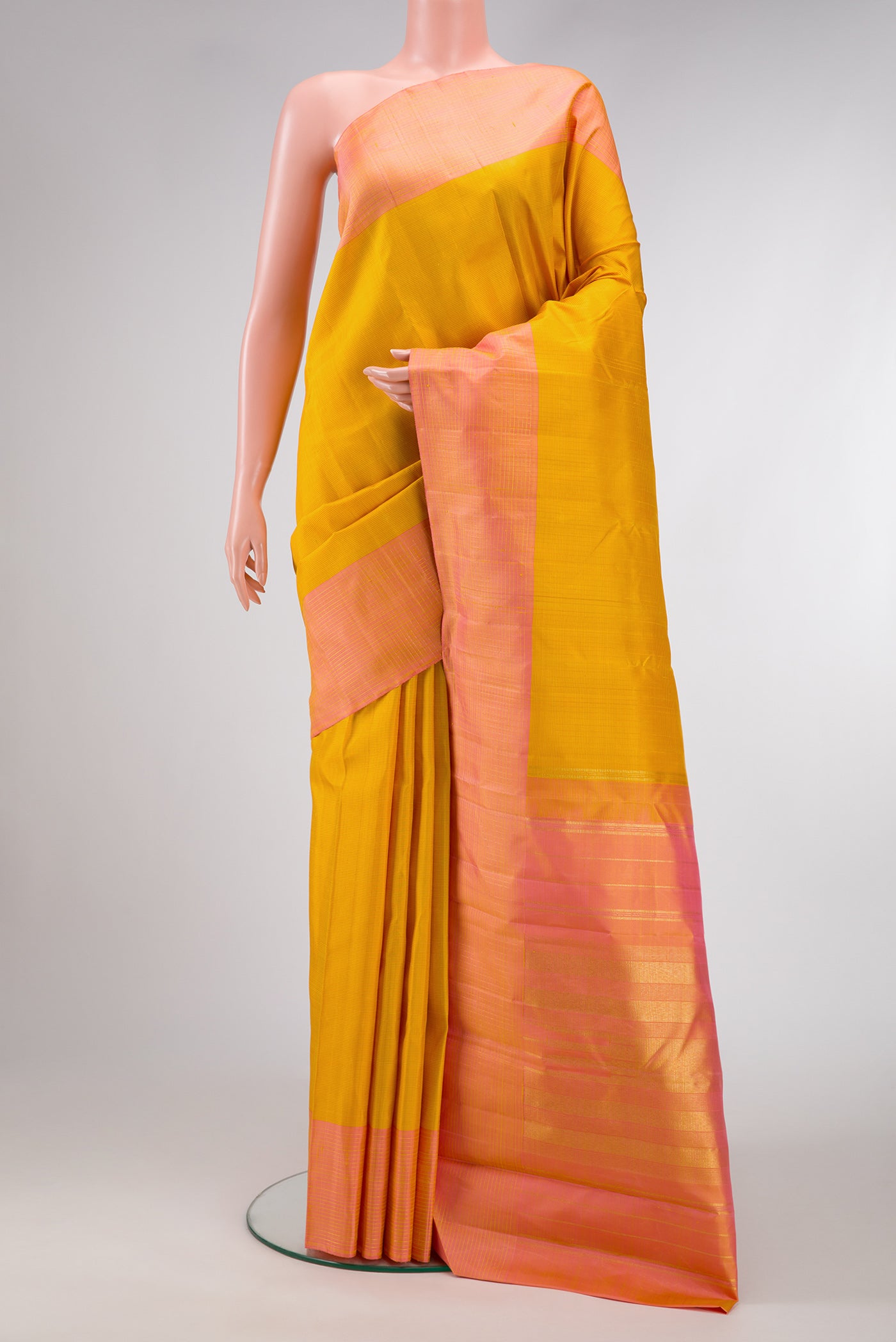 Mustard Dual Tone Kanjivaram Silk Saree with Stripes on the body and Zari Border.  displayed on a mannequin