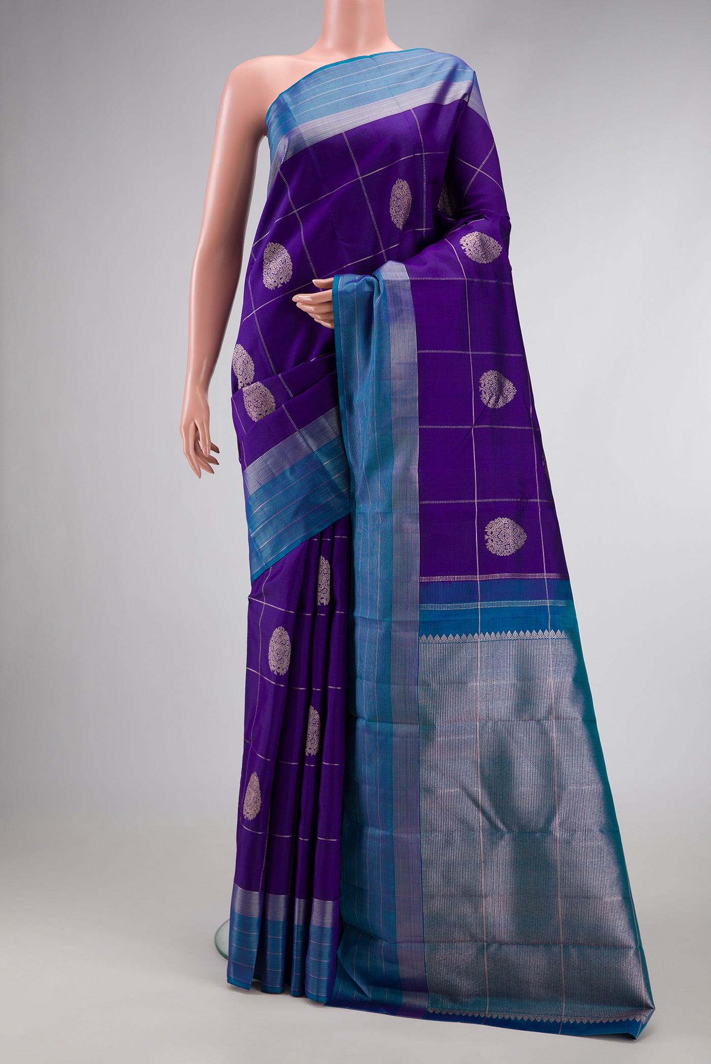 Royal Blue Dual Tone Kanjivaram Silk Saree with Checked design on the body and Zari Border.  displayed on a mannequin