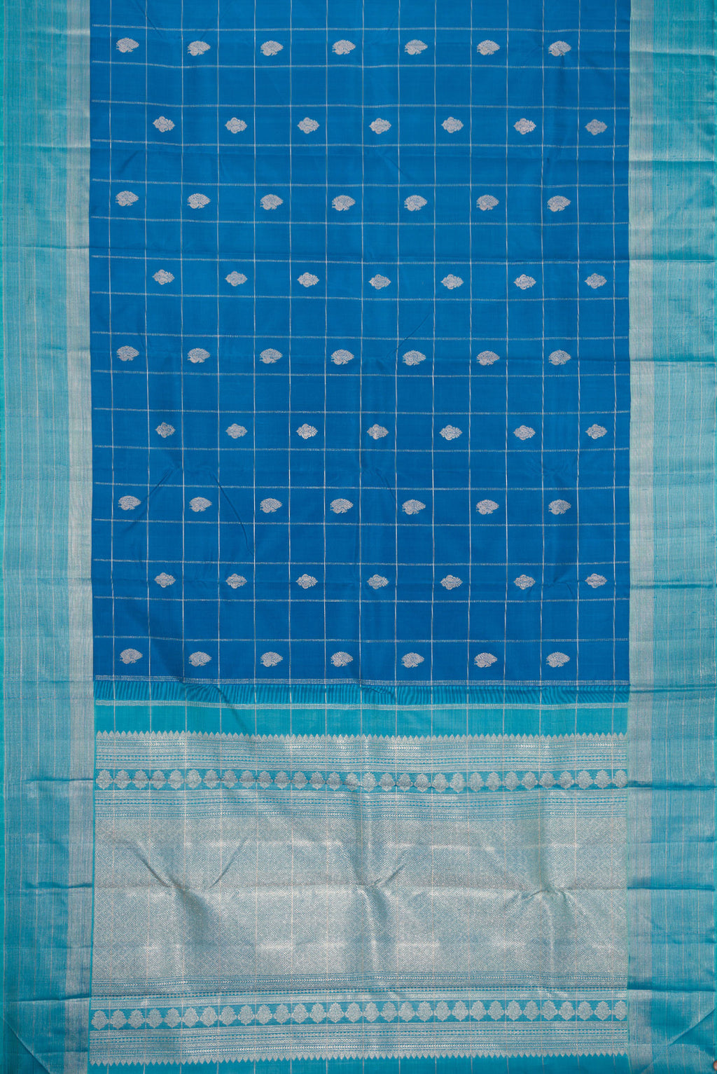 Flat view of Peacock Blue Dual Tone Kanjivaram Silk Saree with Checked design on the body and Zari Border. 