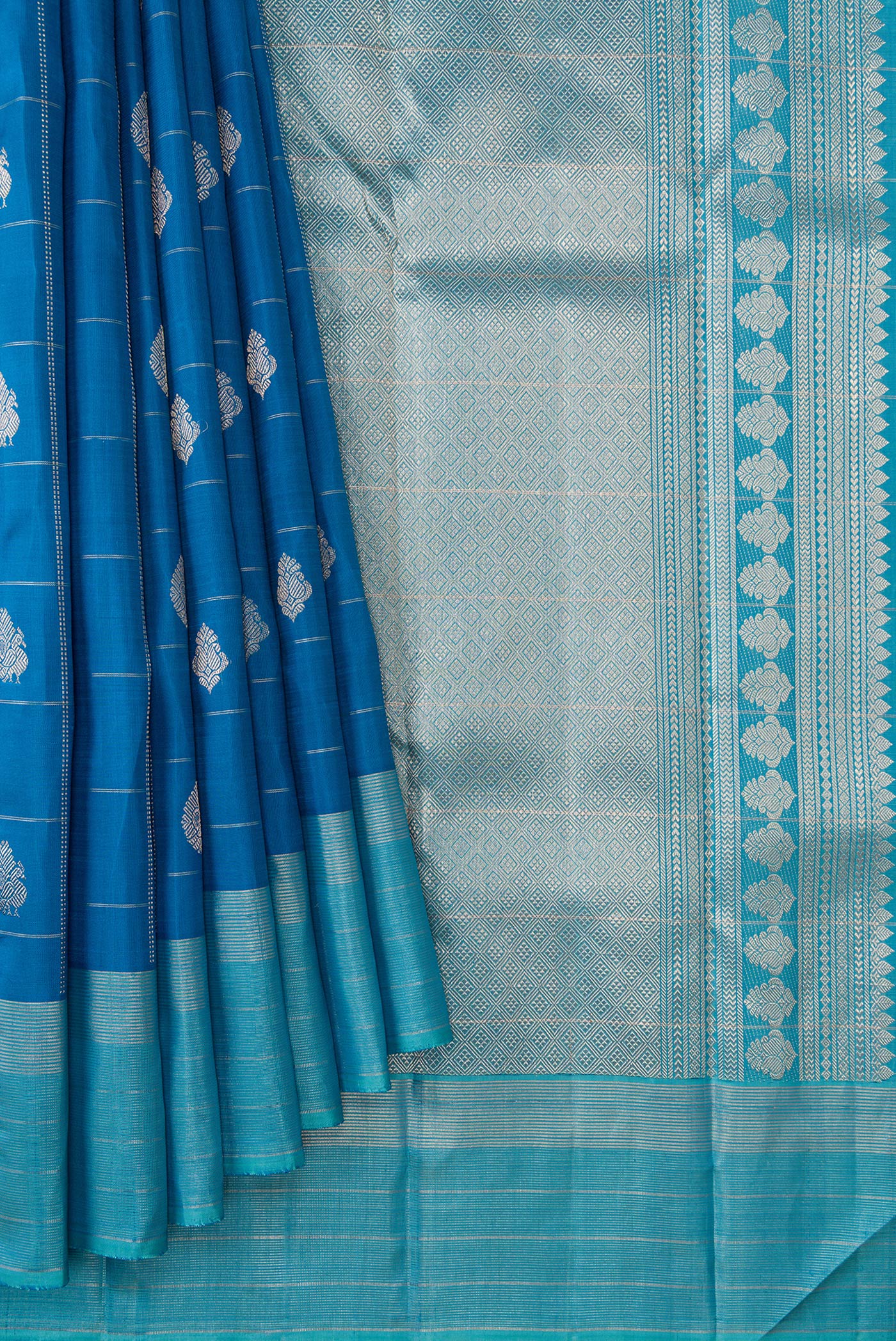 Pleats and pallu of Peacock Blue Dual Tone Kanjivaram Silk Saree with Checked design on the body and Zari Border. 
