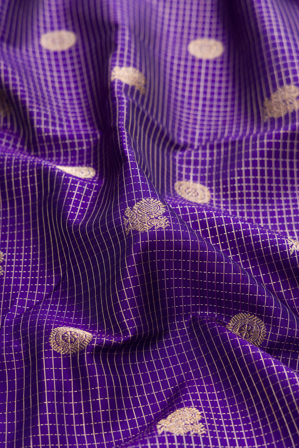 Close up of Violet Kanjivaram Silk Saree with Stripes on the body and Zari Border.  displaying folds