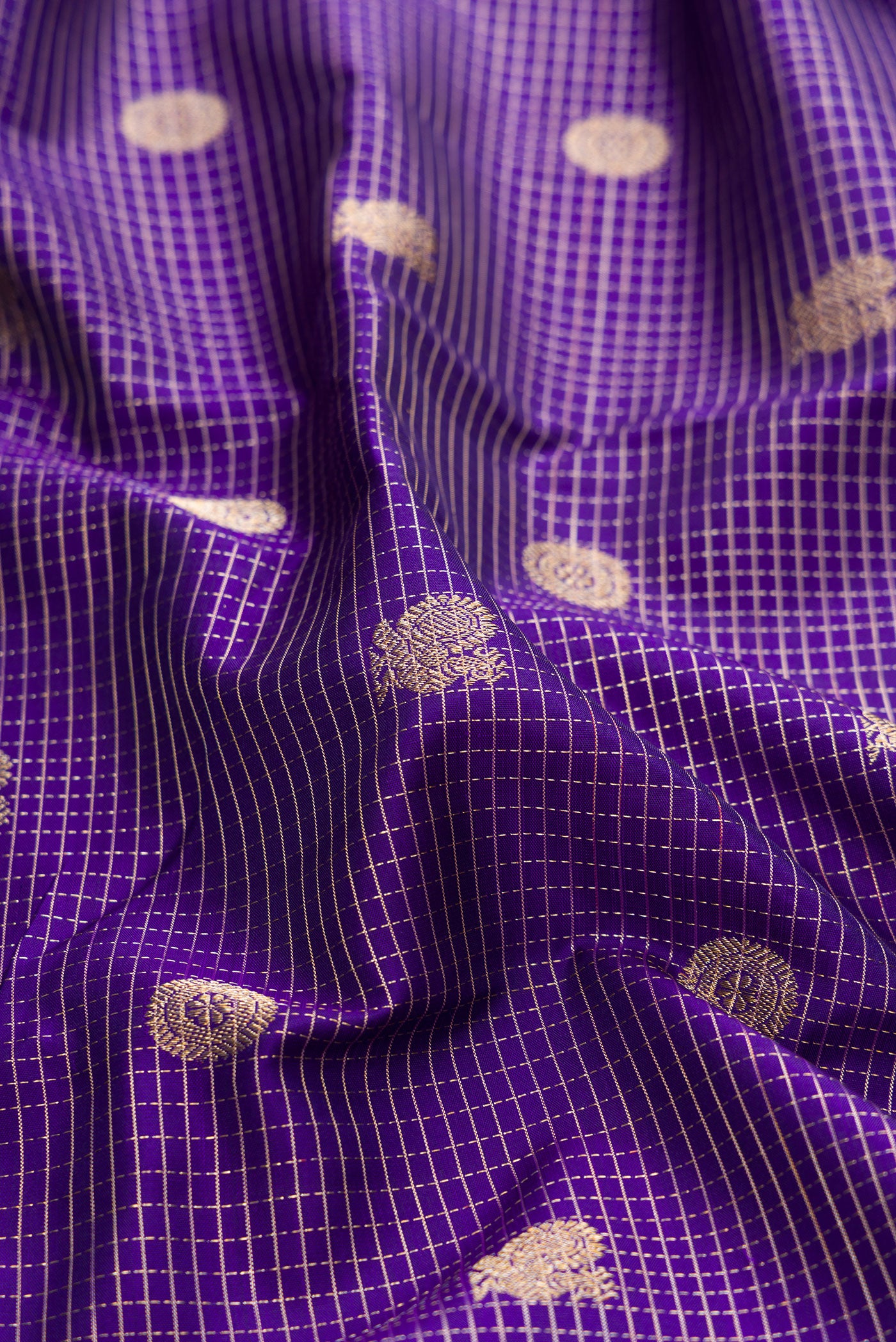 Close up of Violet Kanjivaram Silk Saree with Stripes on the body and Zari Border.  displaying folds