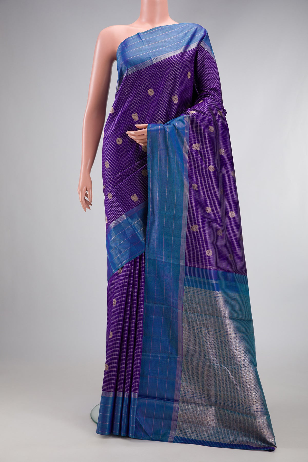 Violet Kanjivaram Silk Saree with Stripes on the body and Zari Border.  displayed on a mannequin