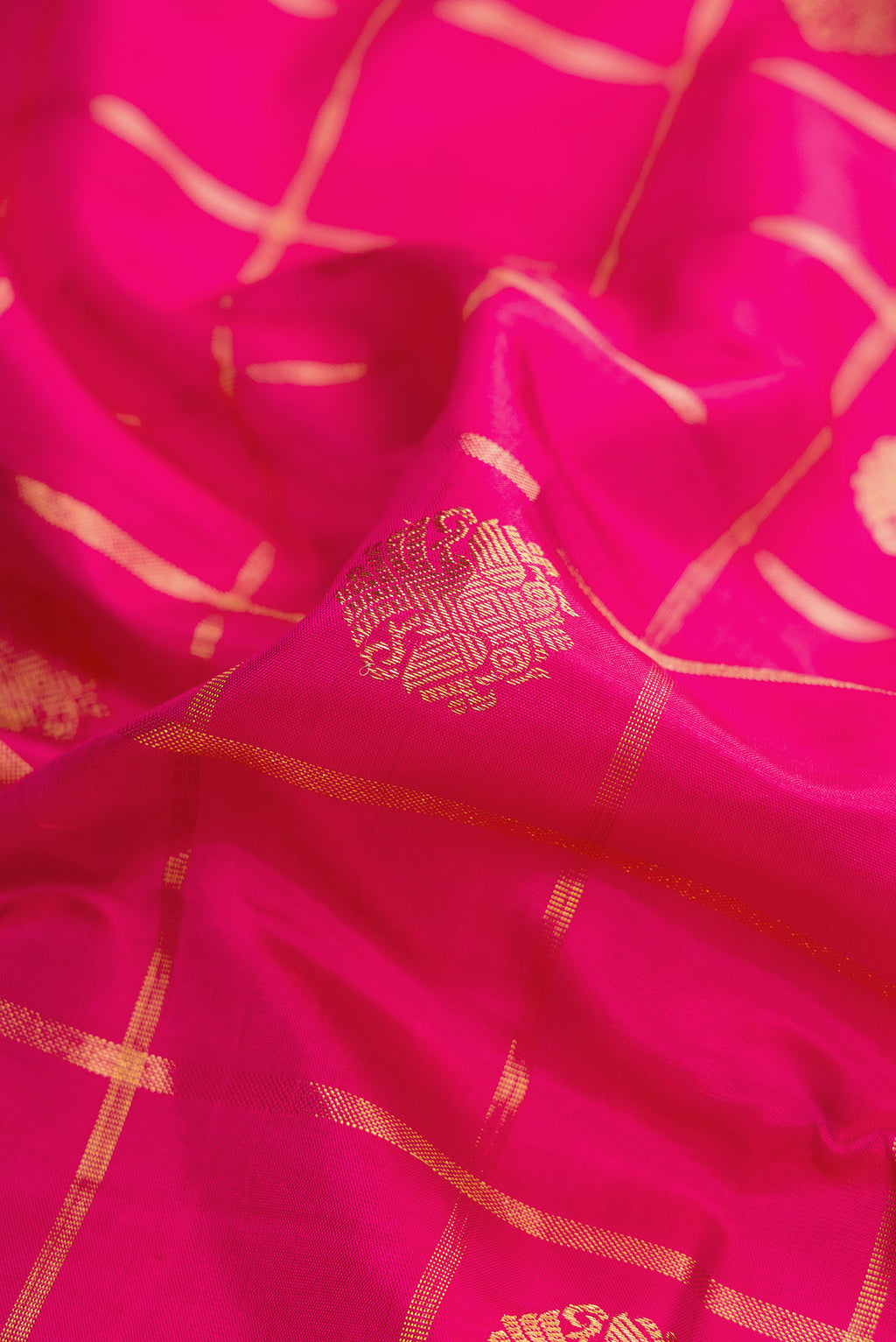 Close up of Pure Silk Pure Zari Pink Dual Tone Kanjivaram Saree with Checked design on the body and Zari Border.  displaying folds