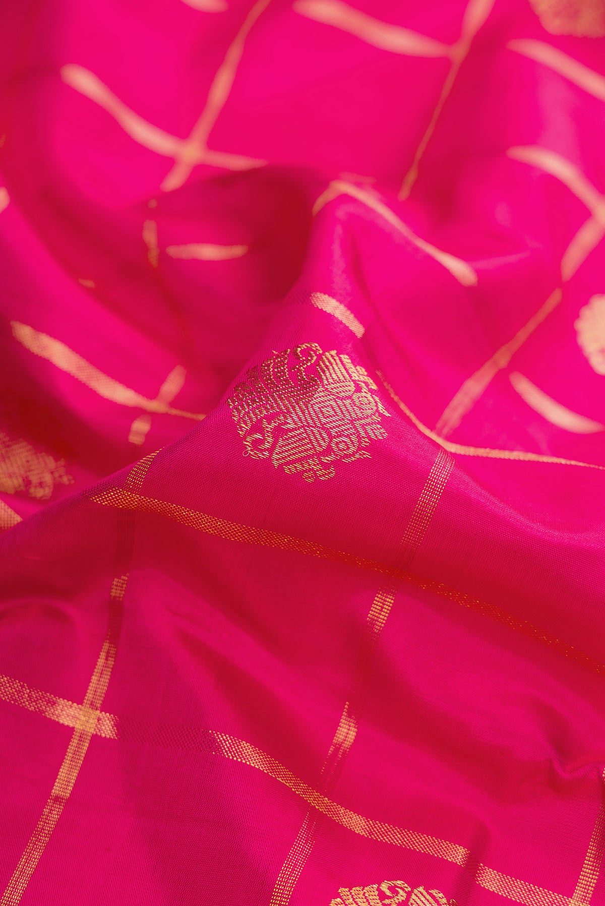 Close up of Pure Silk Pure Zari Pink Dual Tone Kanjivaram Saree with Checked design on the body and Zari Border.  displaying folds