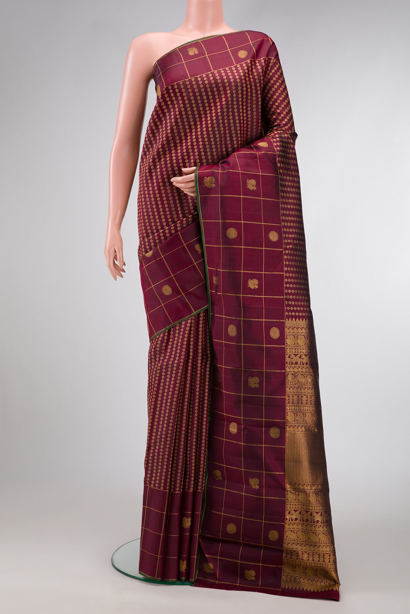Burgundy Dual Tone Kanjivaram Silk Saree with Zari Butta on the body and Fancy Border.  displayed on a mannequin
