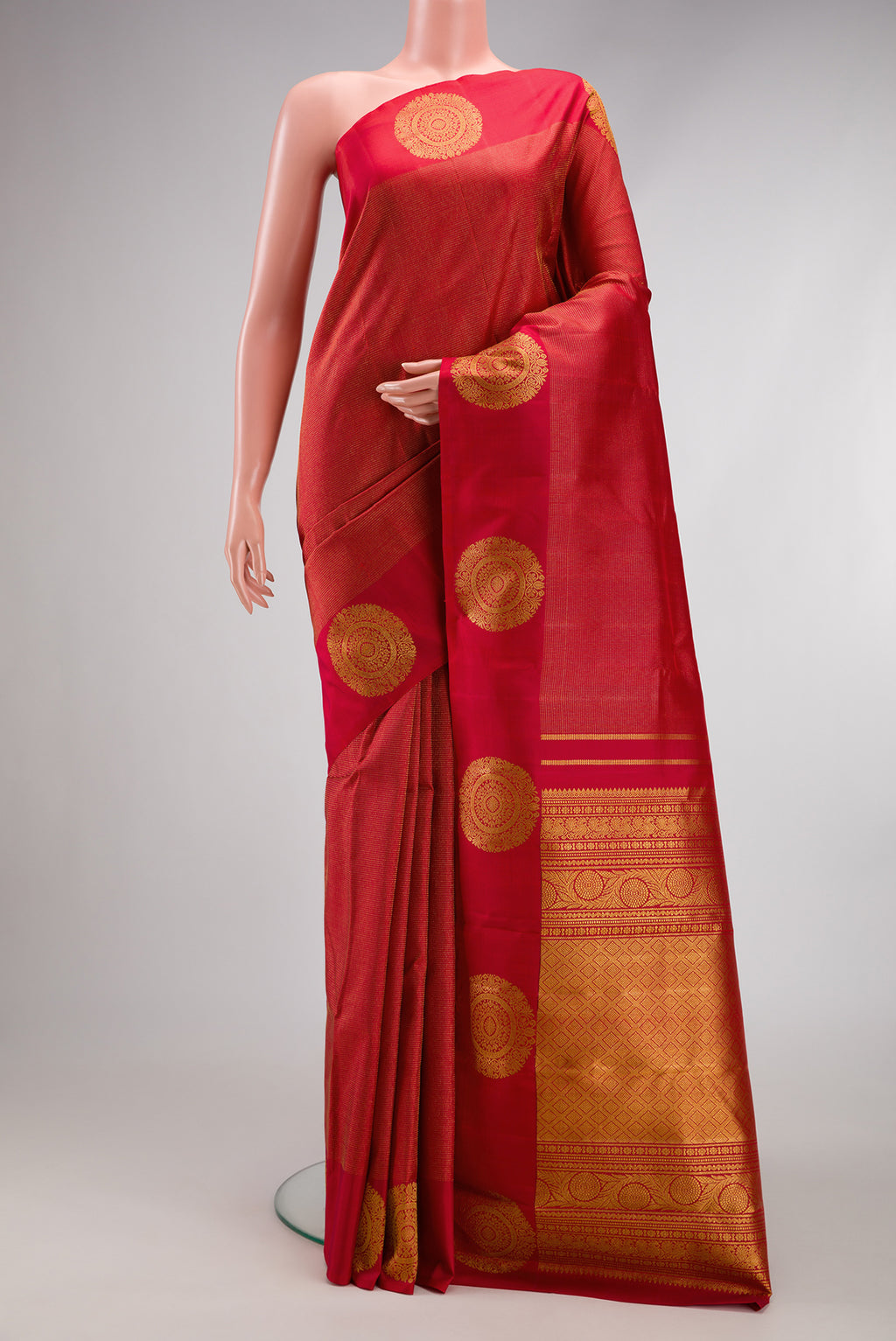 Red Kanjivaram Silk Saree with Zari Brocade on the body and Fancy Border.  displayed on a mannequin