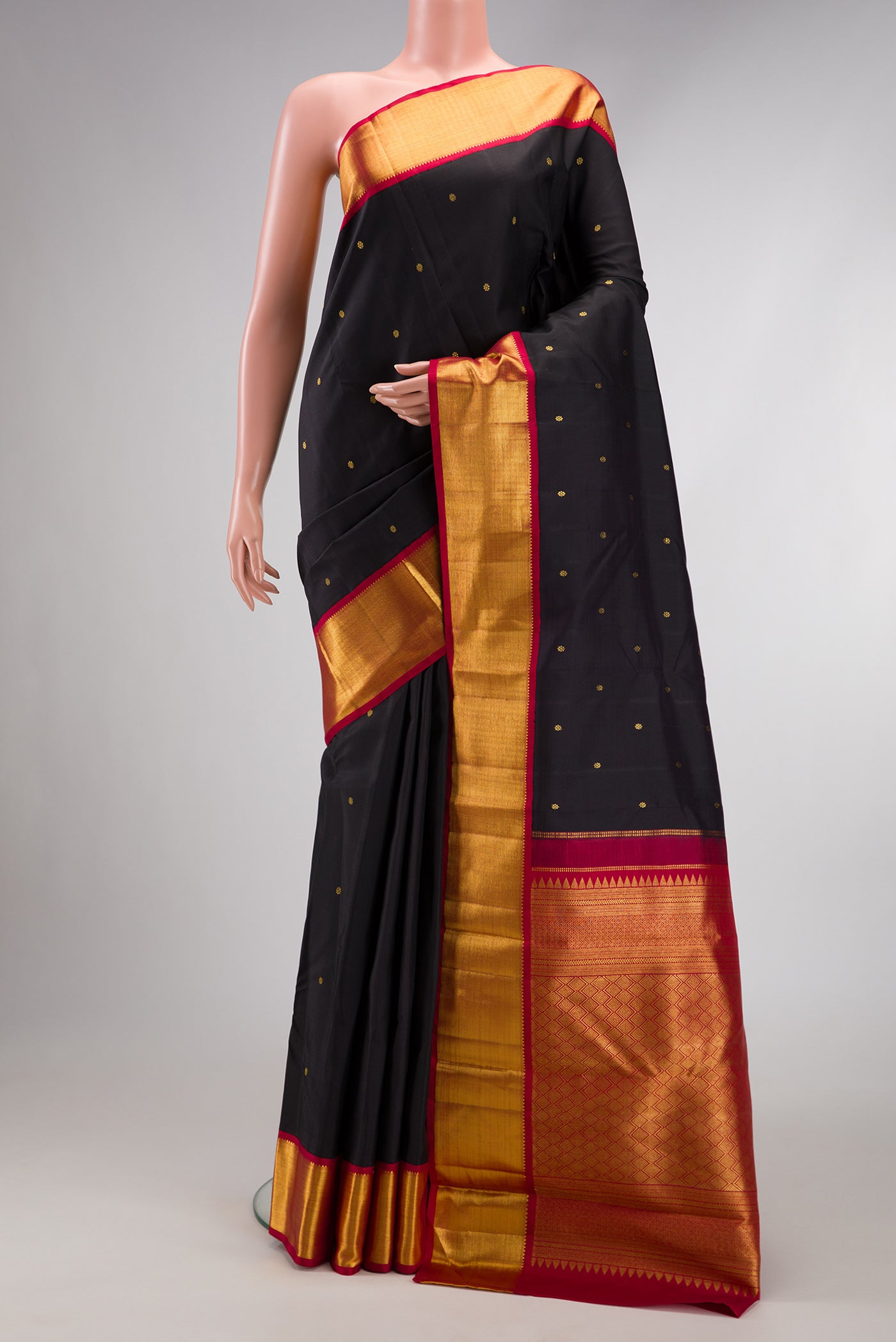 Pure Silk Pure Zari Black Dual Tone Kanchipuram Saree with Zari Butta on the body and Zari Border.  displayed on a mannequin