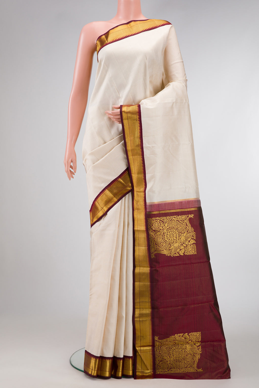 Pure Silk Pure Zari Off White Dual Tone Kanchipuram Saree with Stripes on the body and Zari Border.  displayed on a mannequin
