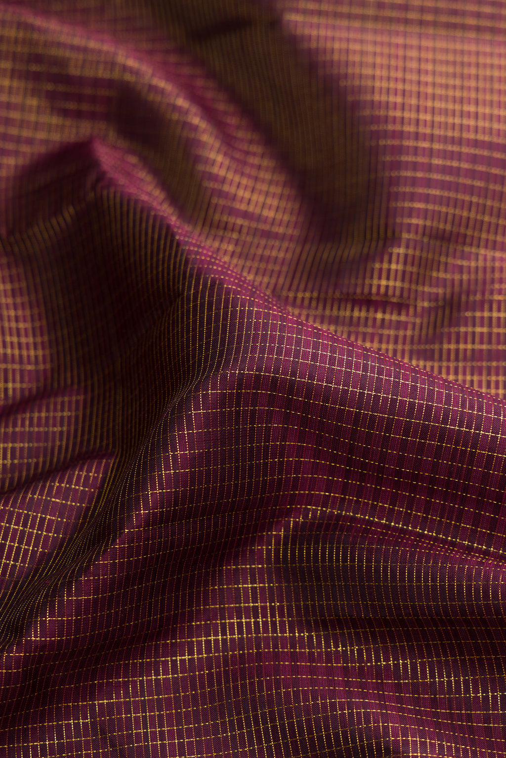 Close up of Brown Dual Tone Kanjivaram Silk Saree with Checked design on the body and Zari Border.  displaying folds