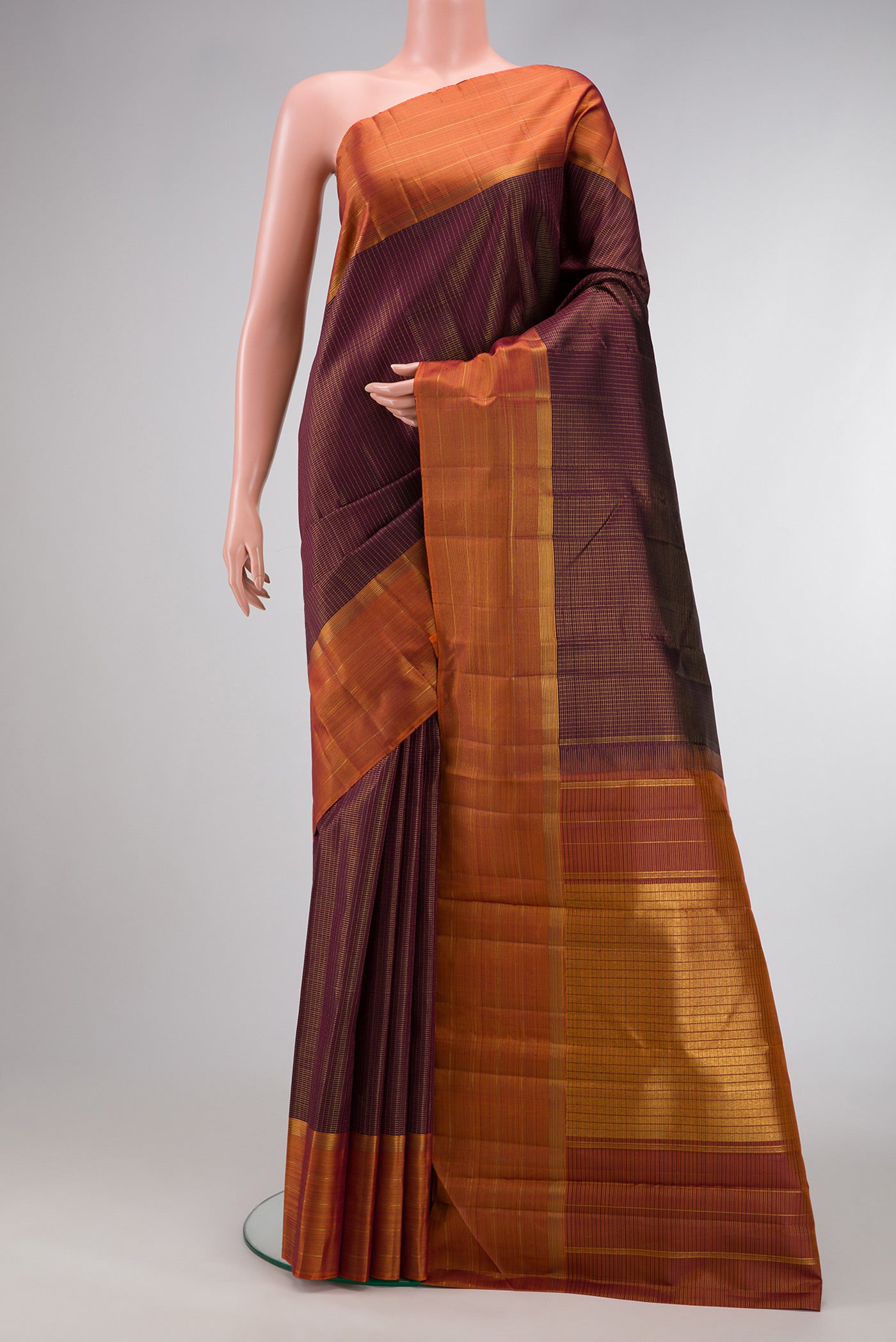 Brown Dual Tone Kanjivaram Silk Saree with Checked design on the body and Zari Border.  displayed on a mannequin