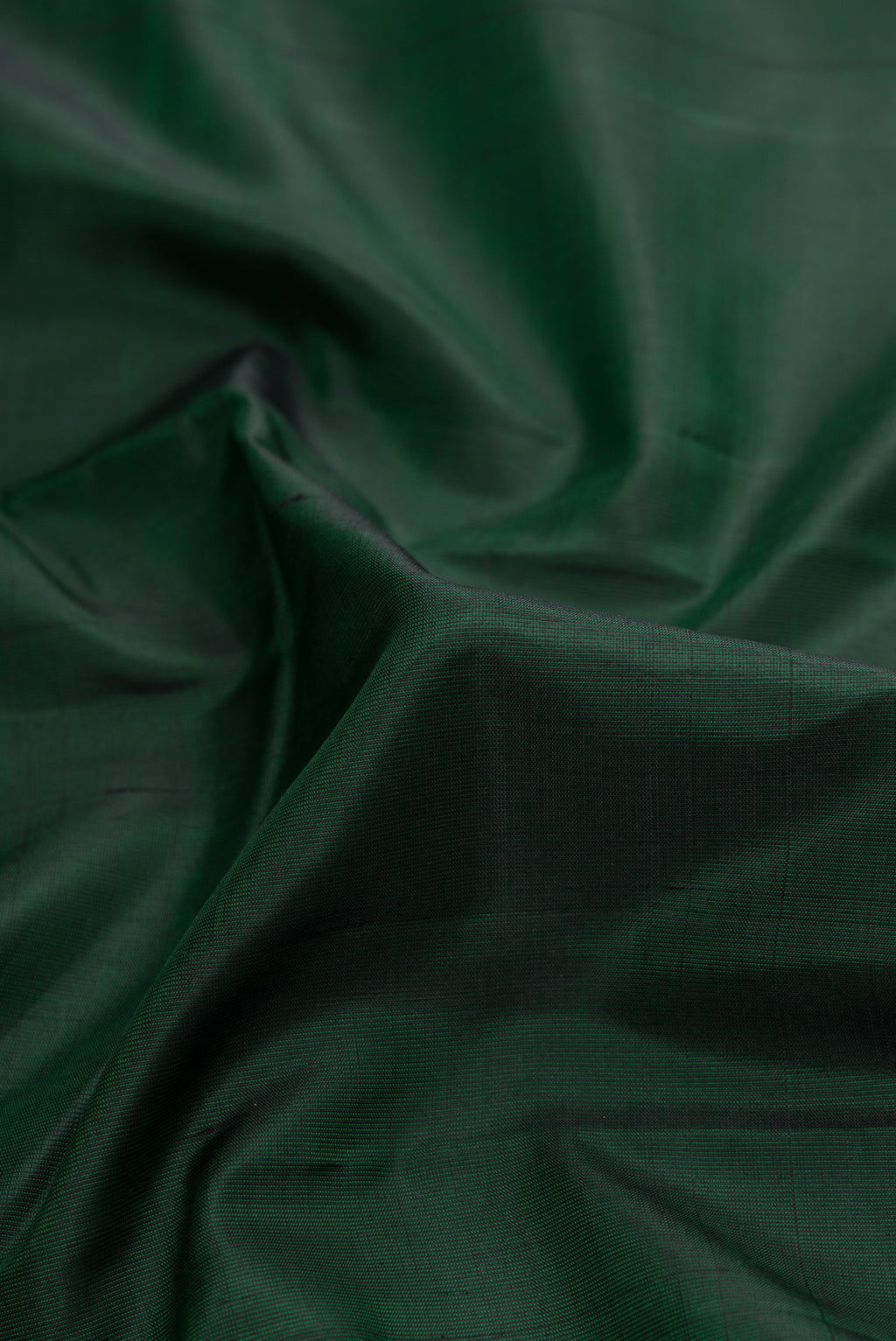Close up of Bottle Green Dual Tone Kanjivaram Silk Saree with Plain Body and Zari Border.  displaying folds