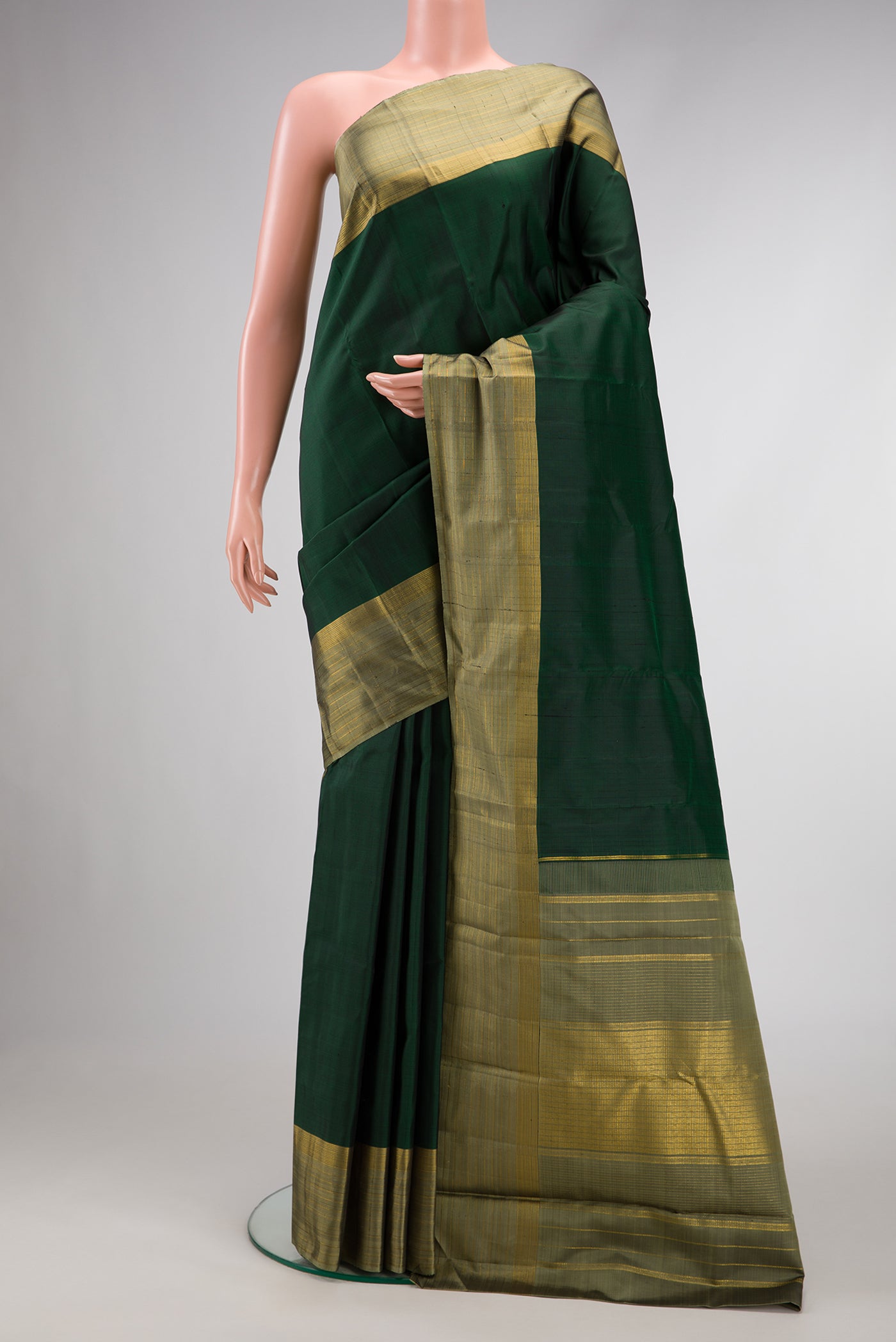 Bottle Green Dual Tone Kanjivaram Silk Saree with Plain Body and Zari Border.  displayed on a mannequin
