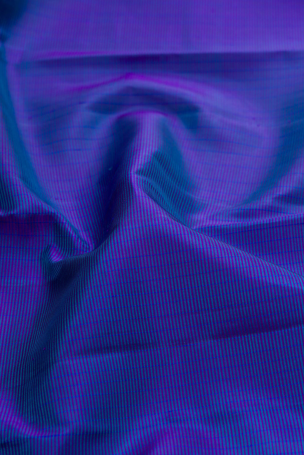 Close up of Royal Blue Kanjivaram Silk Saree with Stripes on the body and Checks Border.  displaying folds