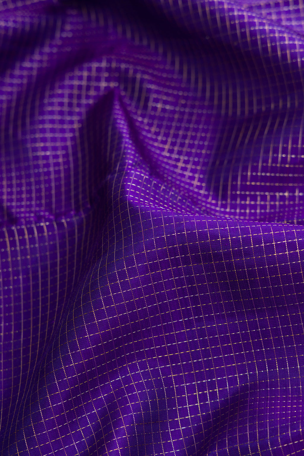 Close up of Violet Dual Tone Kanjivaram Silk Saree with Checked design on the body and Fancy Border.  displaying folds