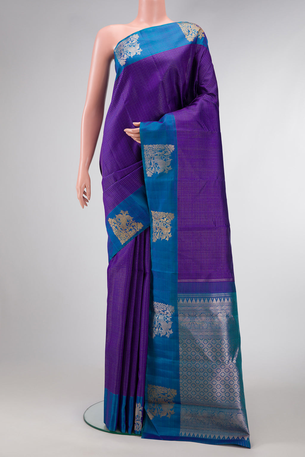 Violet Dual Tone Kanjivaram Silk Saree with Checked design on the body and Fancy Border.  displayed on a mannequin