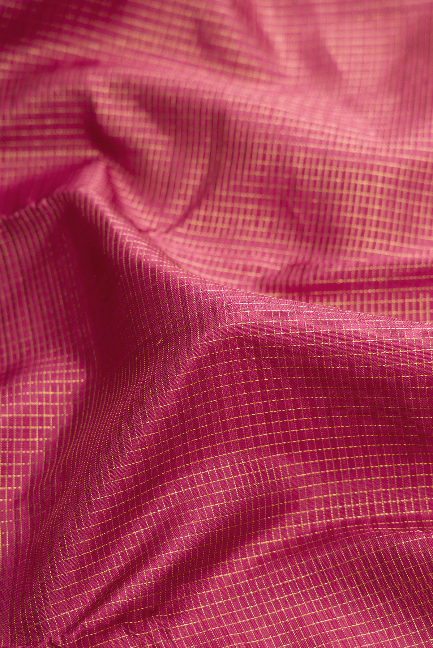 Close up of Pink Dual Tone Kanjivaram Silk Saree with Checked design on the body and Zari Border.  displaying folds