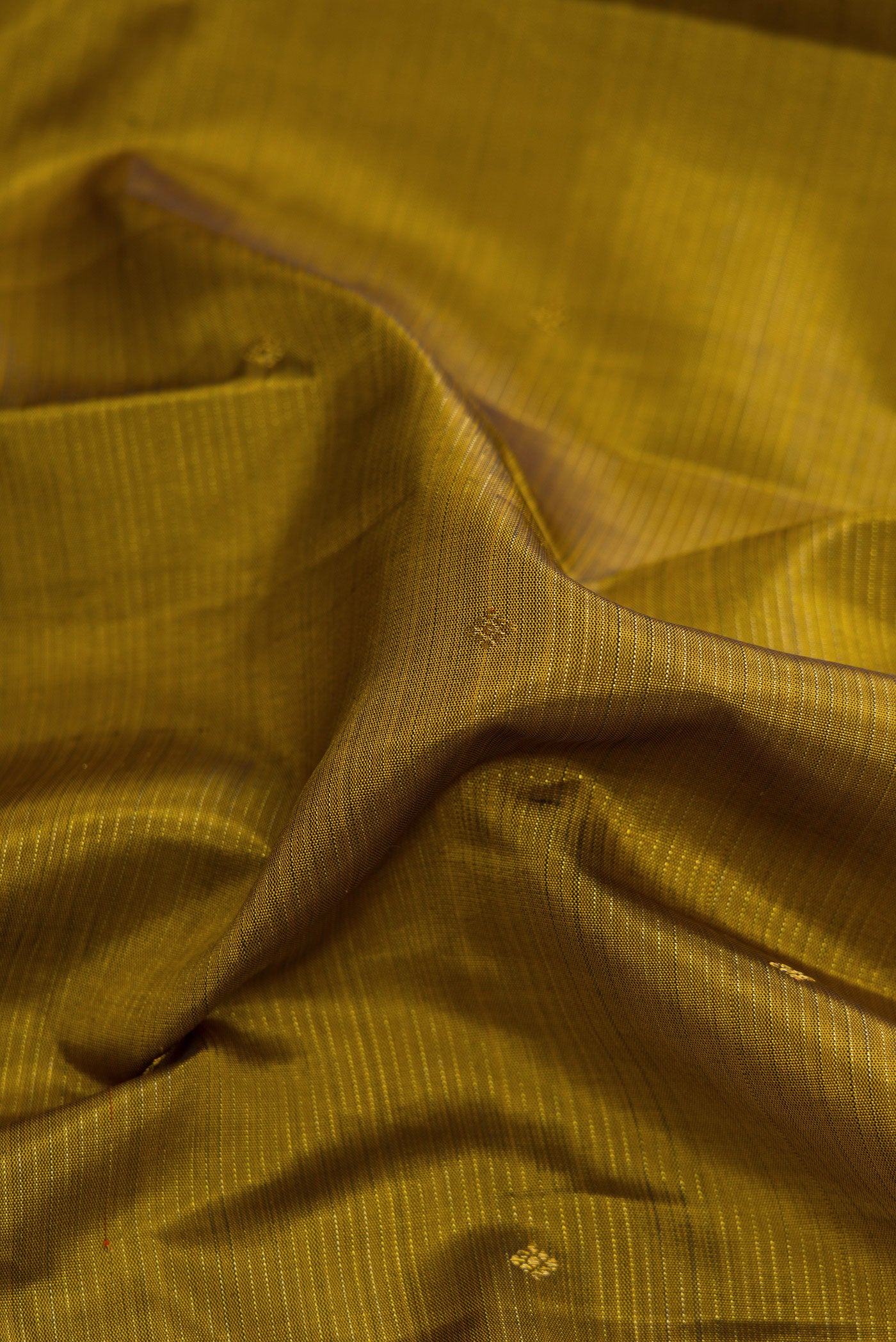 Close up of Mehandi Green Dual Tone Kanjivaram Silk Saree with Stripes on the body and Zari Border.  displaying folds
