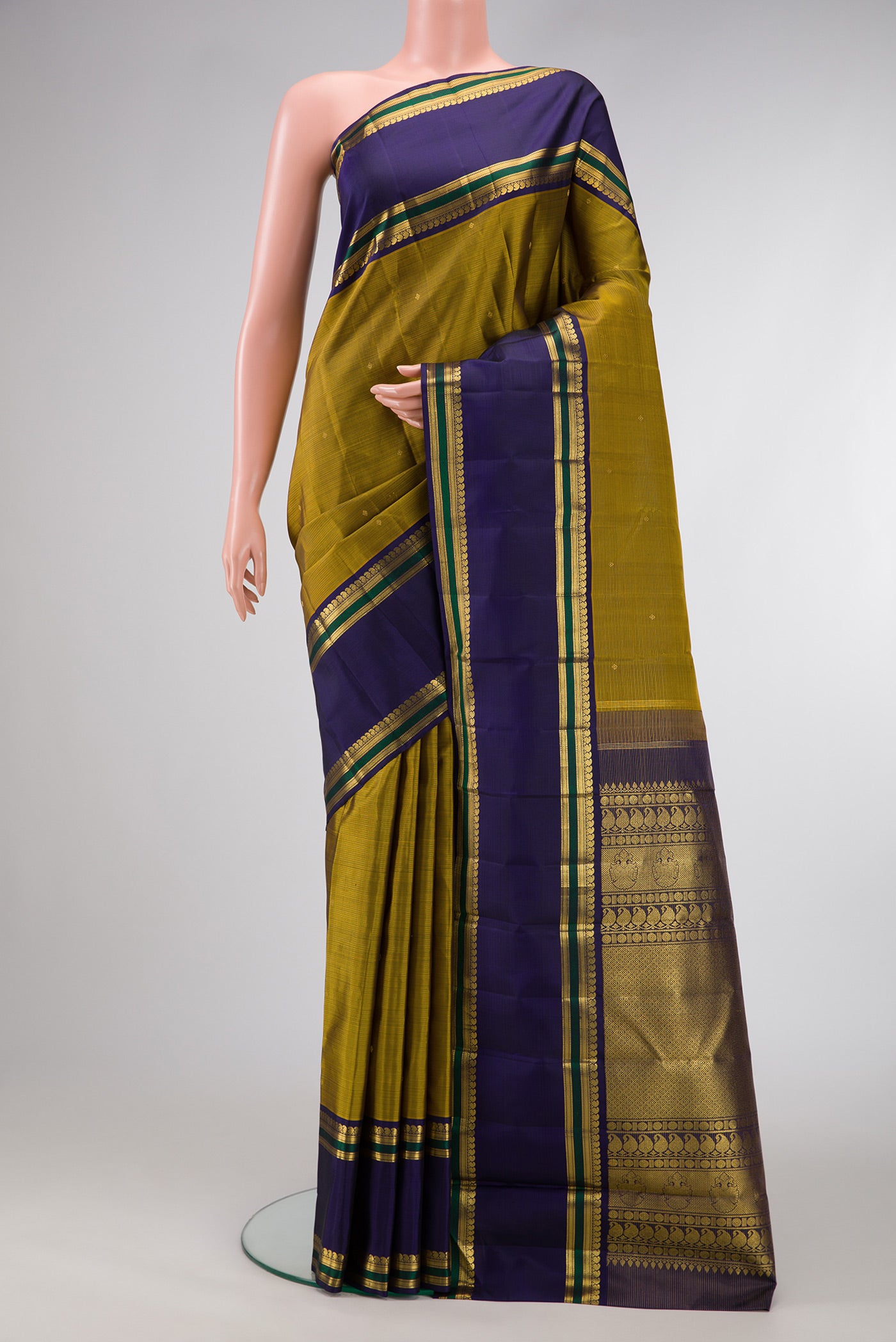 Mehandi Green Dual Tone Kanjivaram Silk Saree with Stripes on the body and Zari Border.  displayed on a mannequin