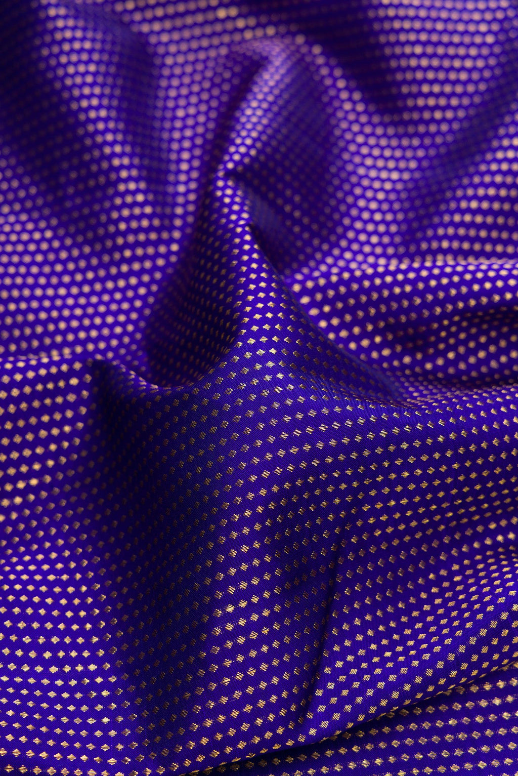 Close up of Royal Blue Dual Tone Kanjivaram Silk Saree with Stripes on the body and Fancy Border.  displaying folds