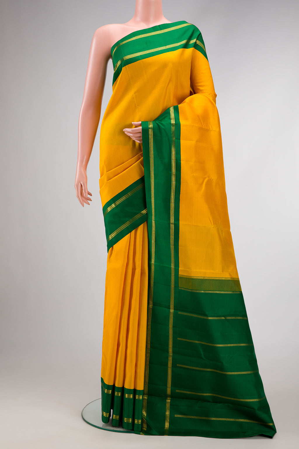Pure Silk Pure Zari Yellow Dual Tone Kanjivaram Saree with Plain Body and Zari Border.  displayed on a mannequin
