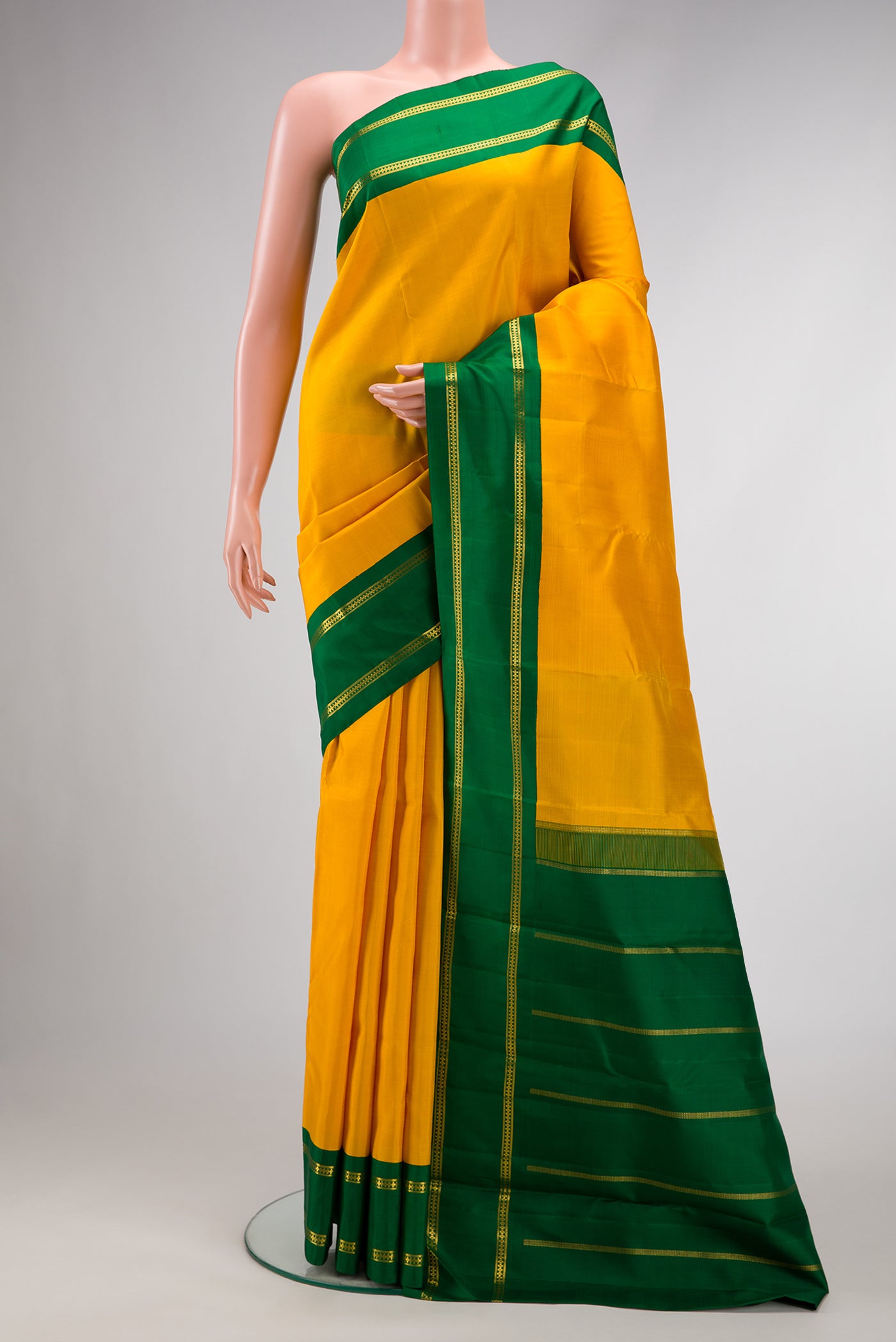 Pure Silk Pure Zari Yellow Dual Tone Kanjivaram Saree with Plain Body and Zari Border.  displayed on a mannequin