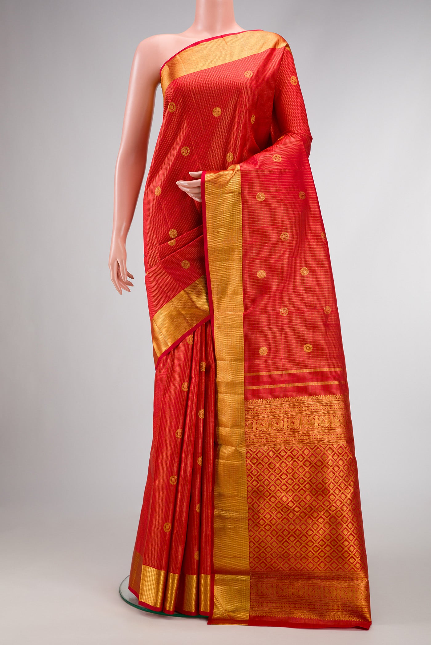 Red Dual Tone Kanchipuram Silk Saree with Checked design on the body and Zari Border.  displayed on a mannequin