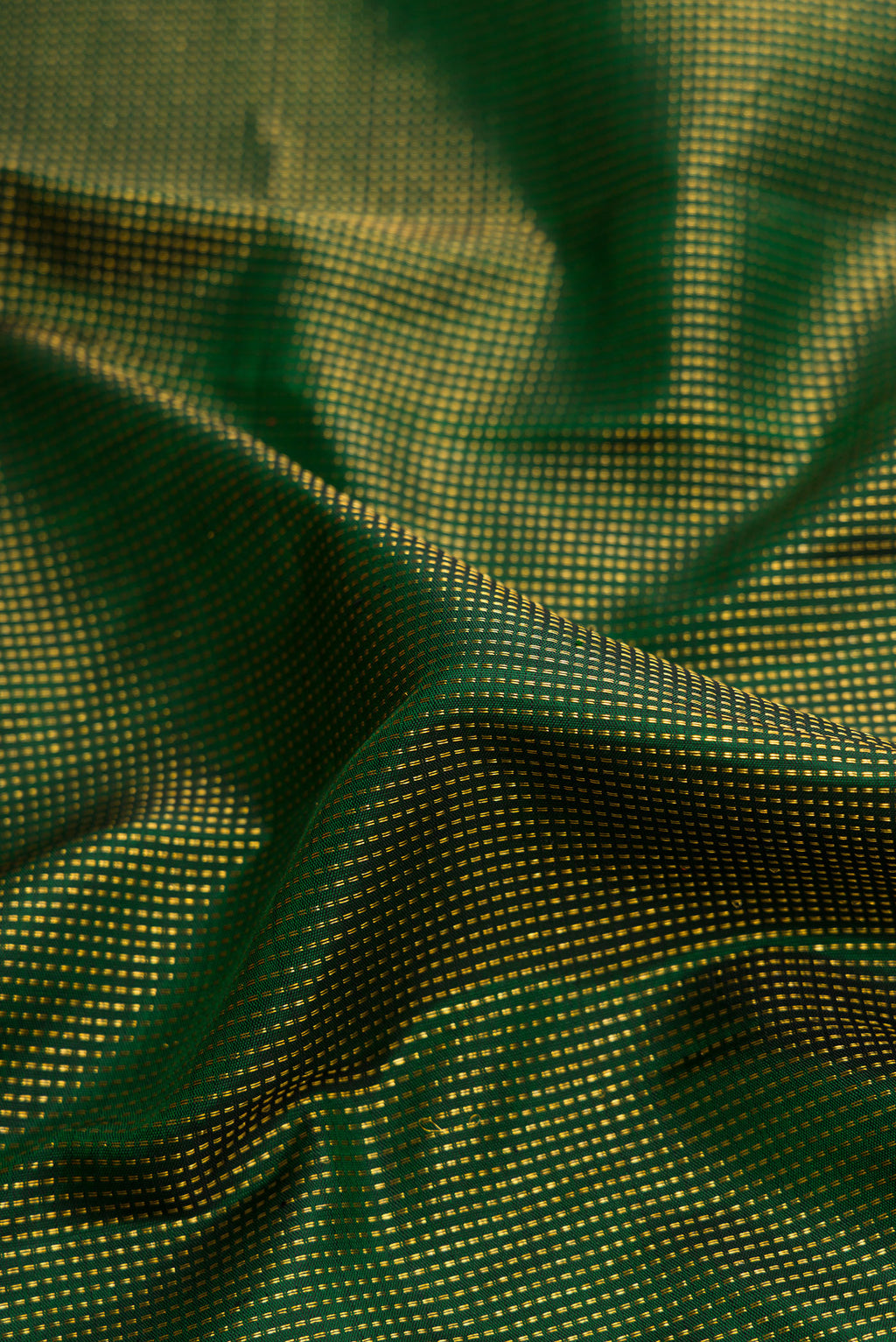 Close up of Green Dual Tone Kanchipuram Silk Saree with Stripes on the body and Zari Border.  displaying folds