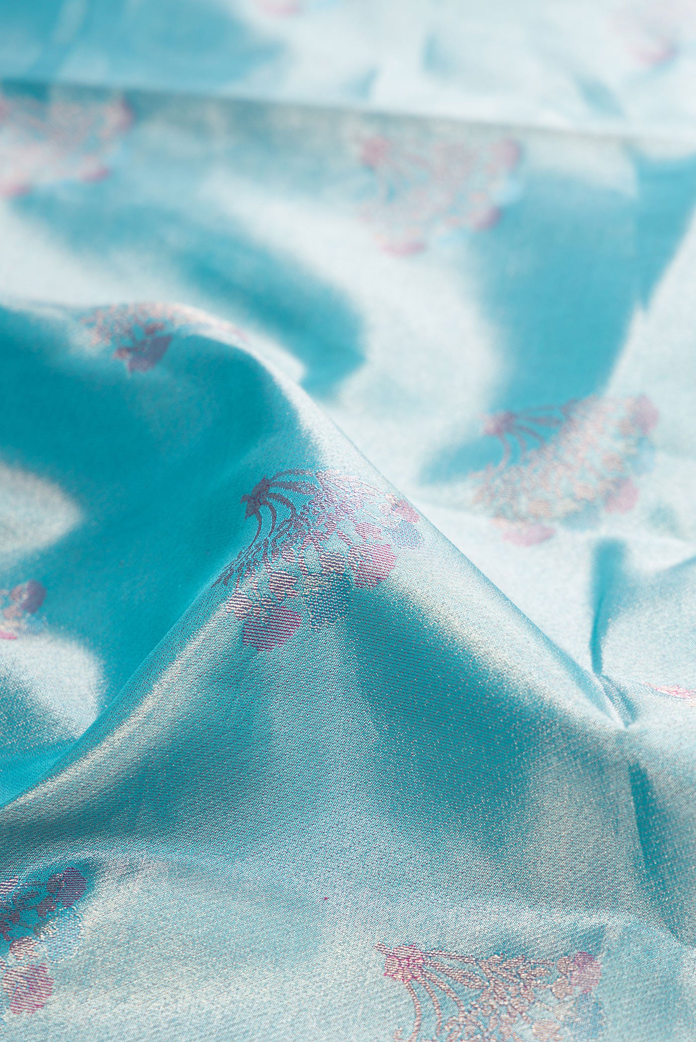 Close up of Sky Blue Dual Tone Kanjivaram Tissue Silk Saree with Zari Brocade on the body and Fancy Border.  displaying folds