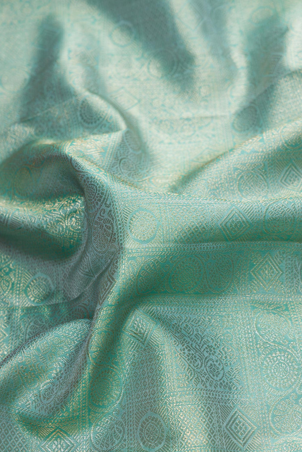 Close up of Sky Blue Dual Tone Kanchipuram Silk Saree with Zari Brocade on the body and Zari Border.  displaying folds