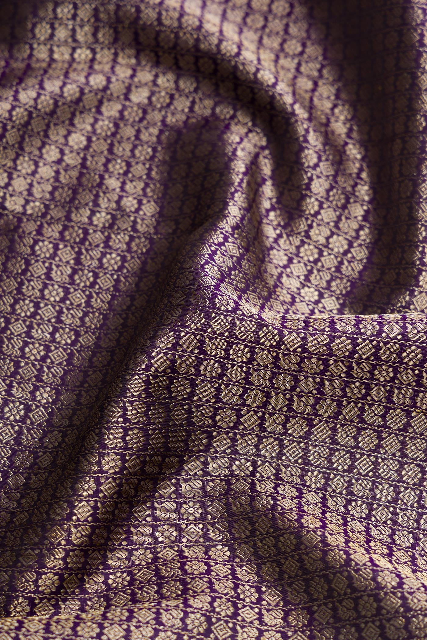 Close up of Violet Dual Tone Kanchipuram Silk Saree with Zari Brocade on the body and Zari Border.  displaying folds