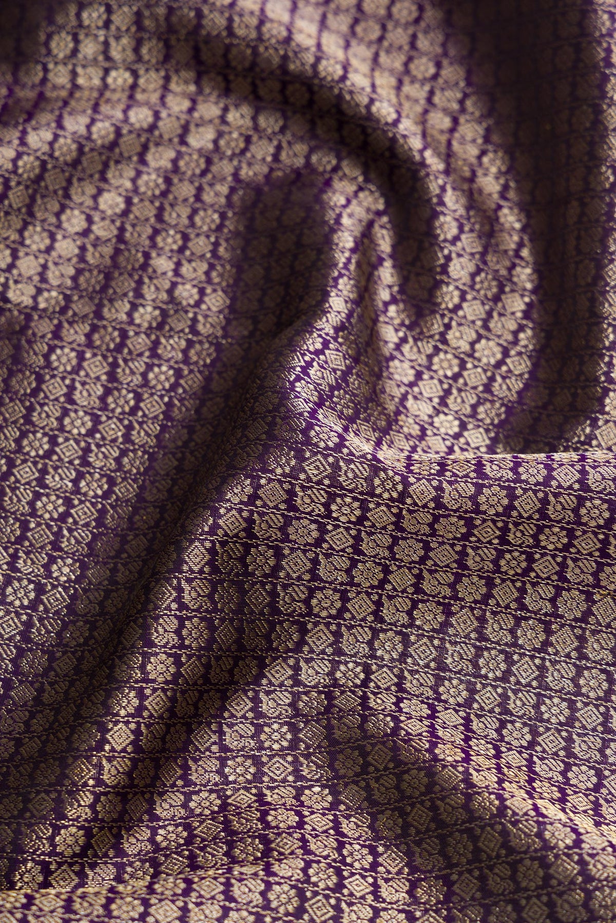 Close up of Violet Dual Tone Kanchipuram Silk Saree with Zari Brocade on the body and Zari Border.  displaying folds