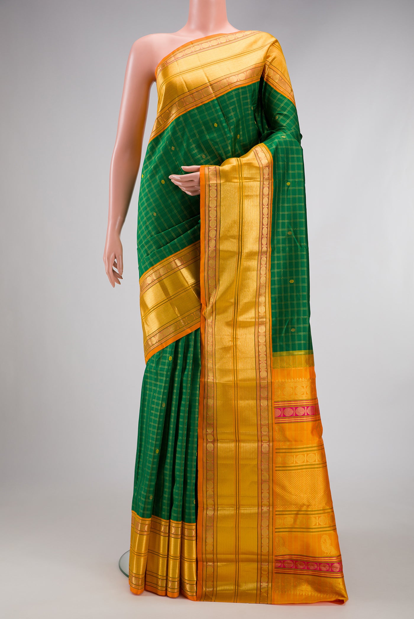 Green Kanjivaram Silk Saree with Checked design on the body and Zari Border.  displayed on a mannequin