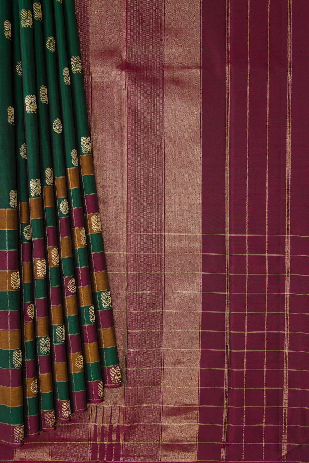 Pleats and pallu of Bottle Green Kanjivaram Silk Saree with Zari Butta on the body and Checks Border. 