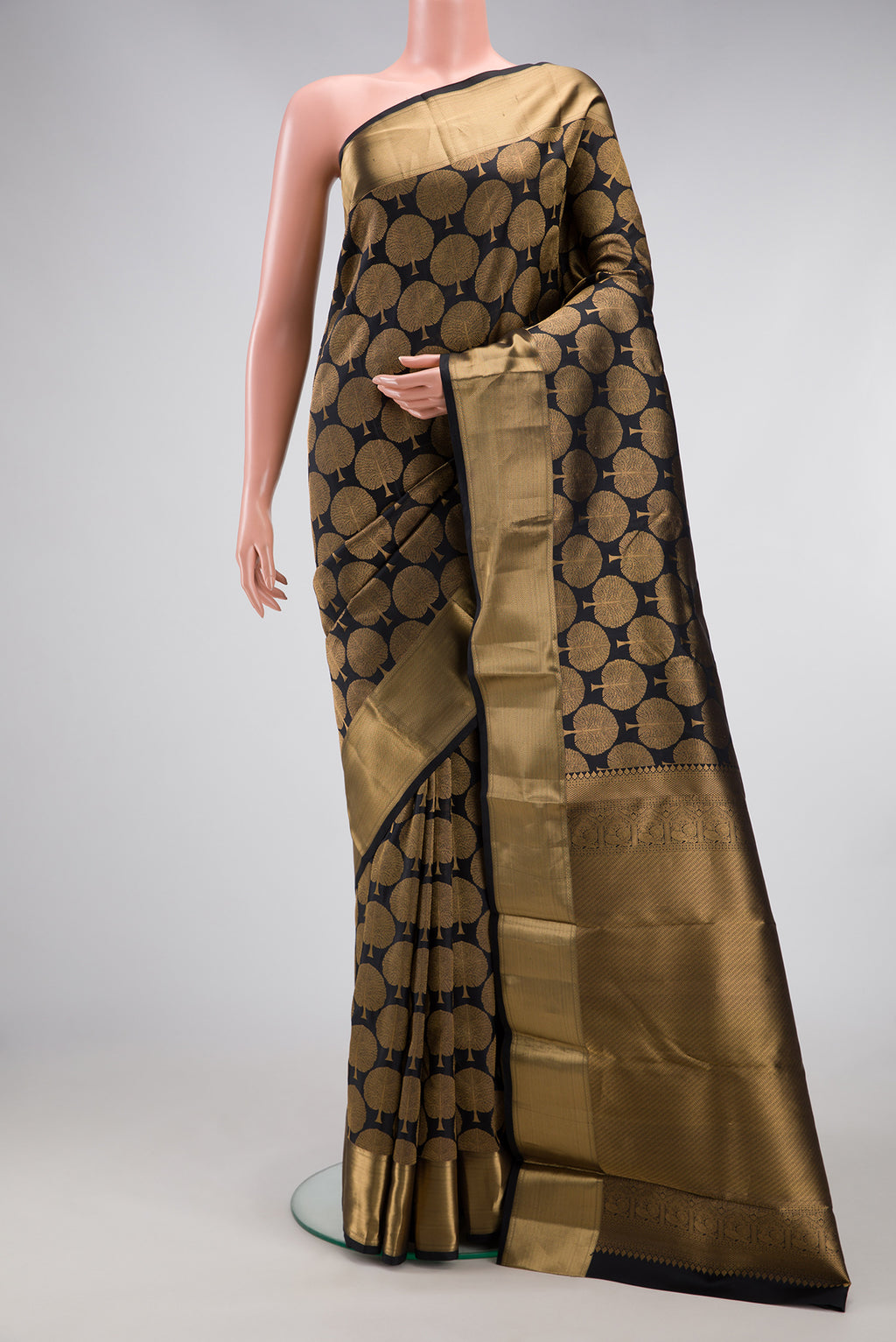 Black Kanjivaram Silk Saree with Zari Brocade on the body and Zari Border.  displayed on a mannequin