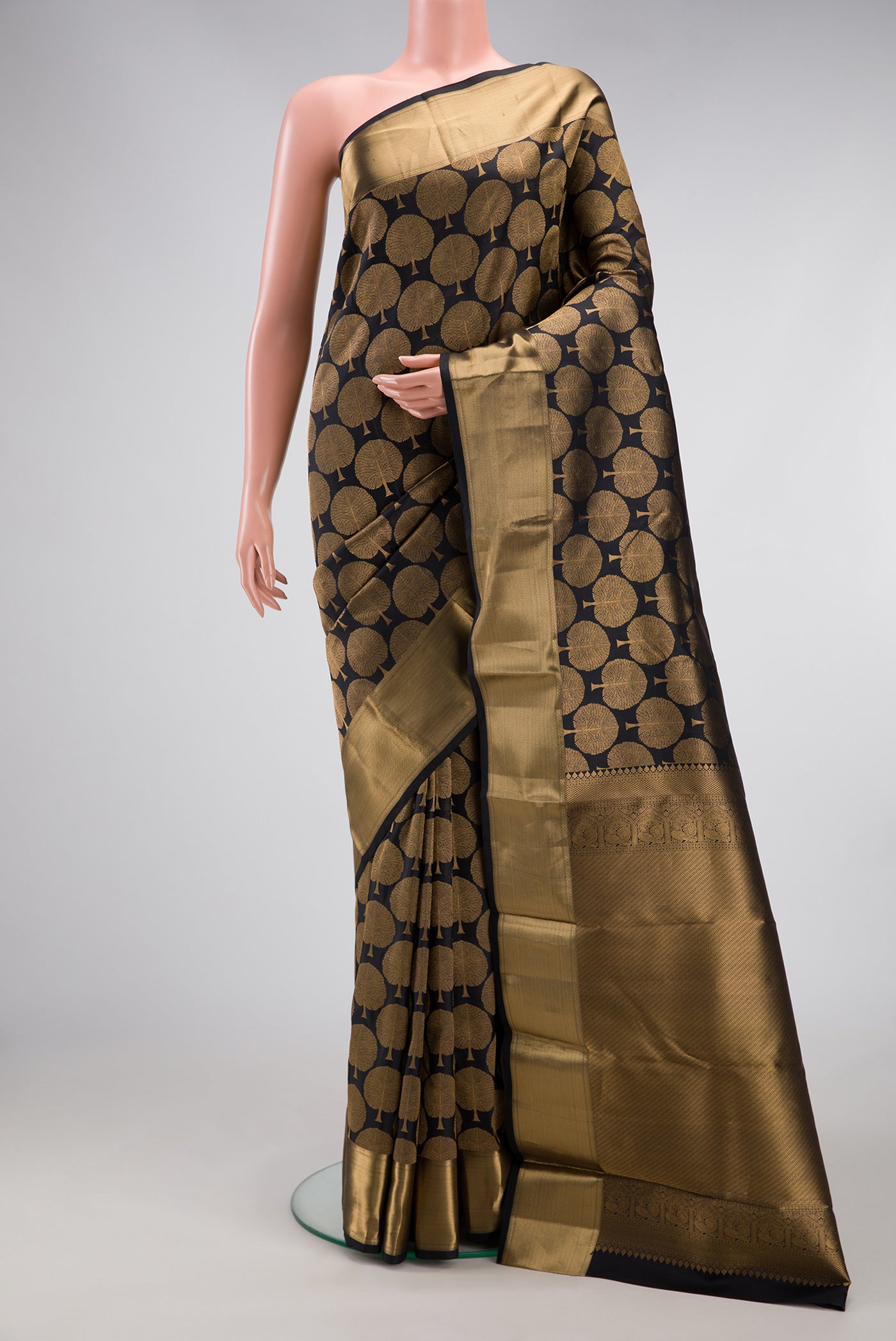 Black Kanjivaram Silk Saree with Zari Brocade on the body and Zari Border.  displayed on a mannequin