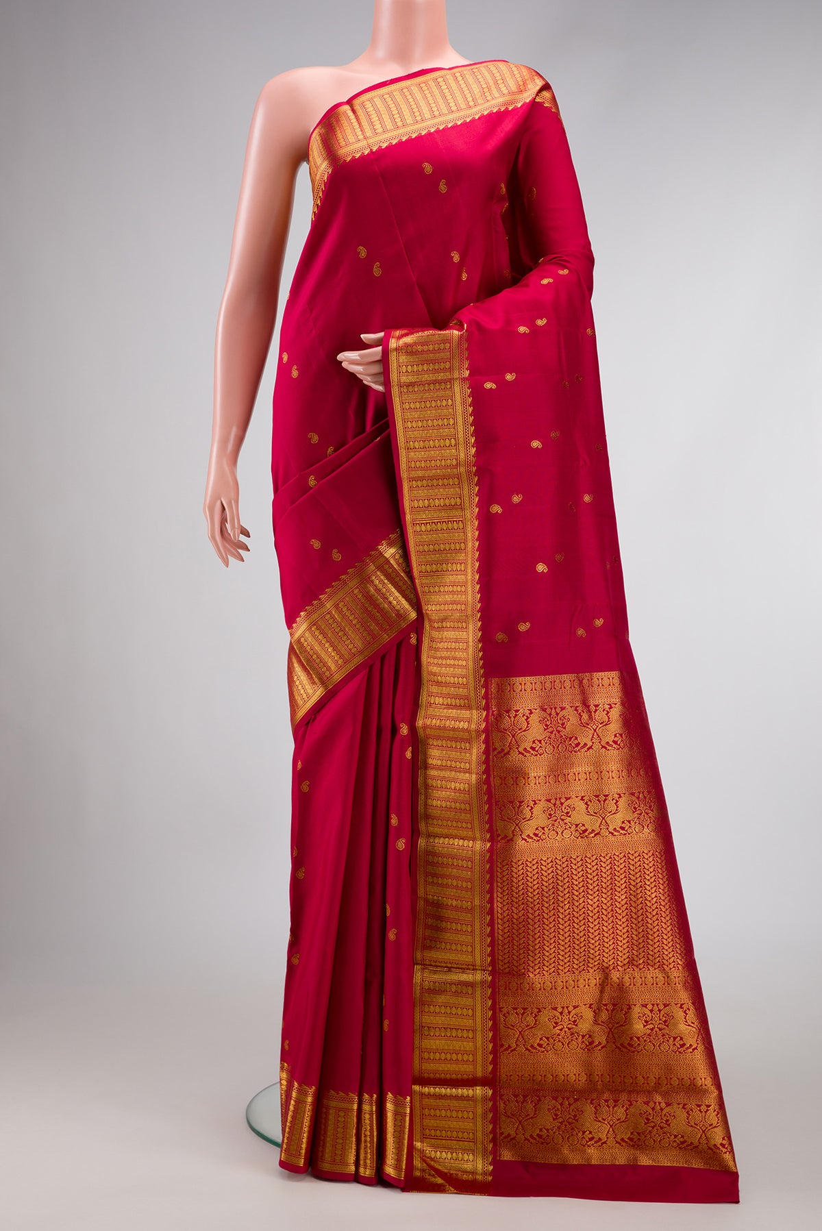Red Dual Tone Kanjivaram Silk Saree with Zari Butta on the body and Zari Border.  displayed on a mannequin