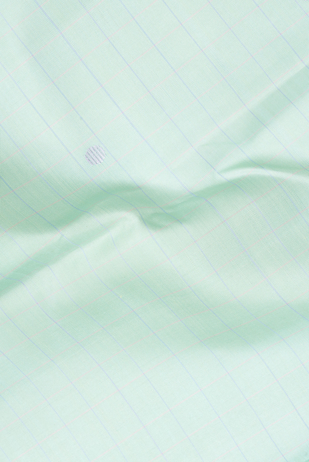 Close up of Pure Silk Pista Green Dual Tone Kanjivaram Saree with Checked design on the body and Plain Border.  displaying folds