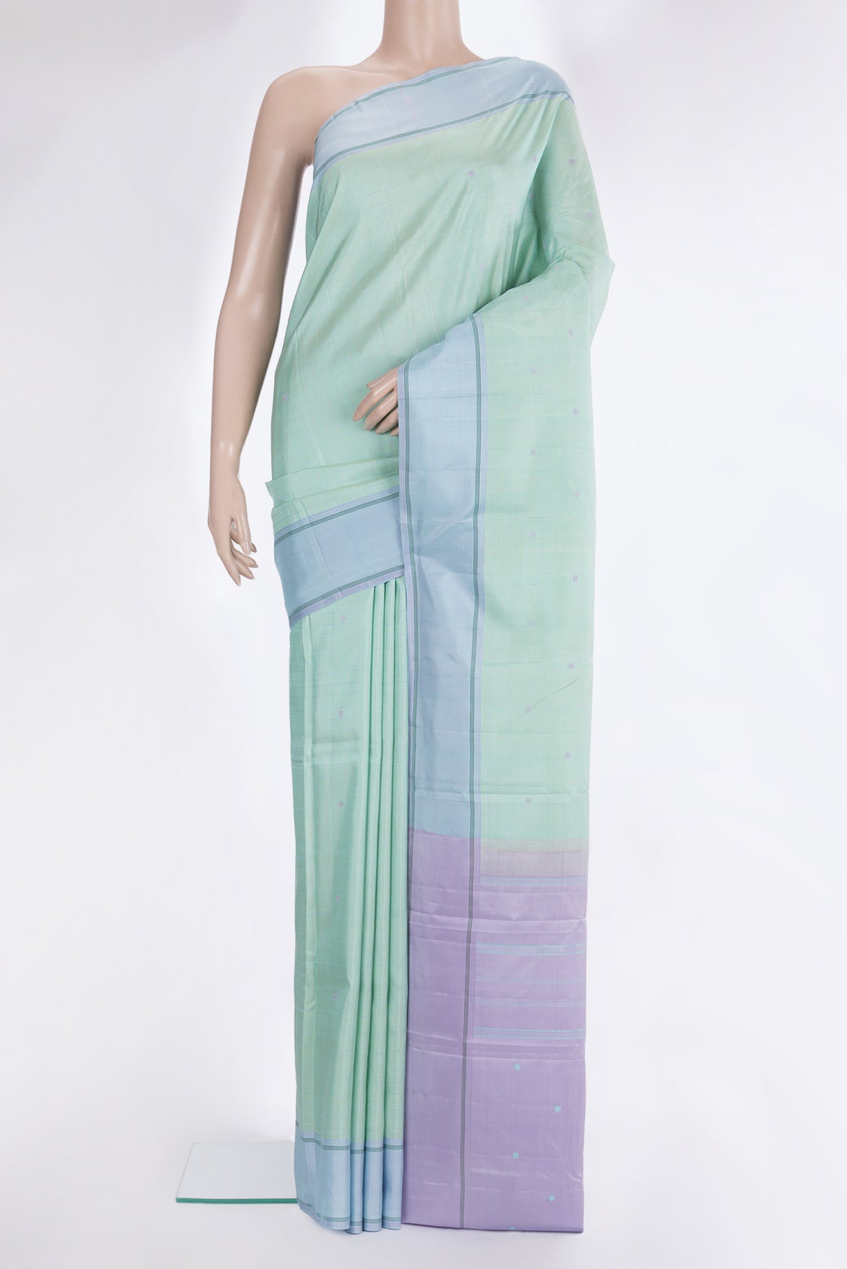 Pure Silk Pista Green Dual Tone Kanjivaram Saree with Checked design on the body and Plain Border.  displayed on a mannequin