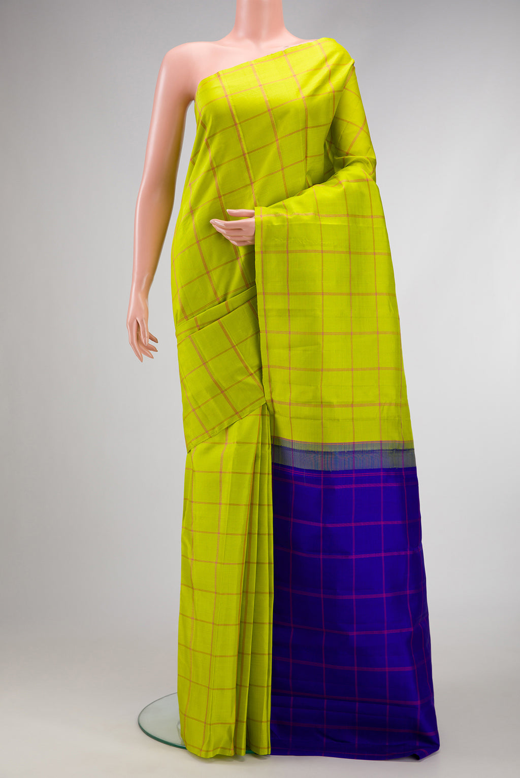 Parrot Green Dual Tone Kanjivaram Silk Saree with Checked design on the body and Without Border.  displayed on a mannequin