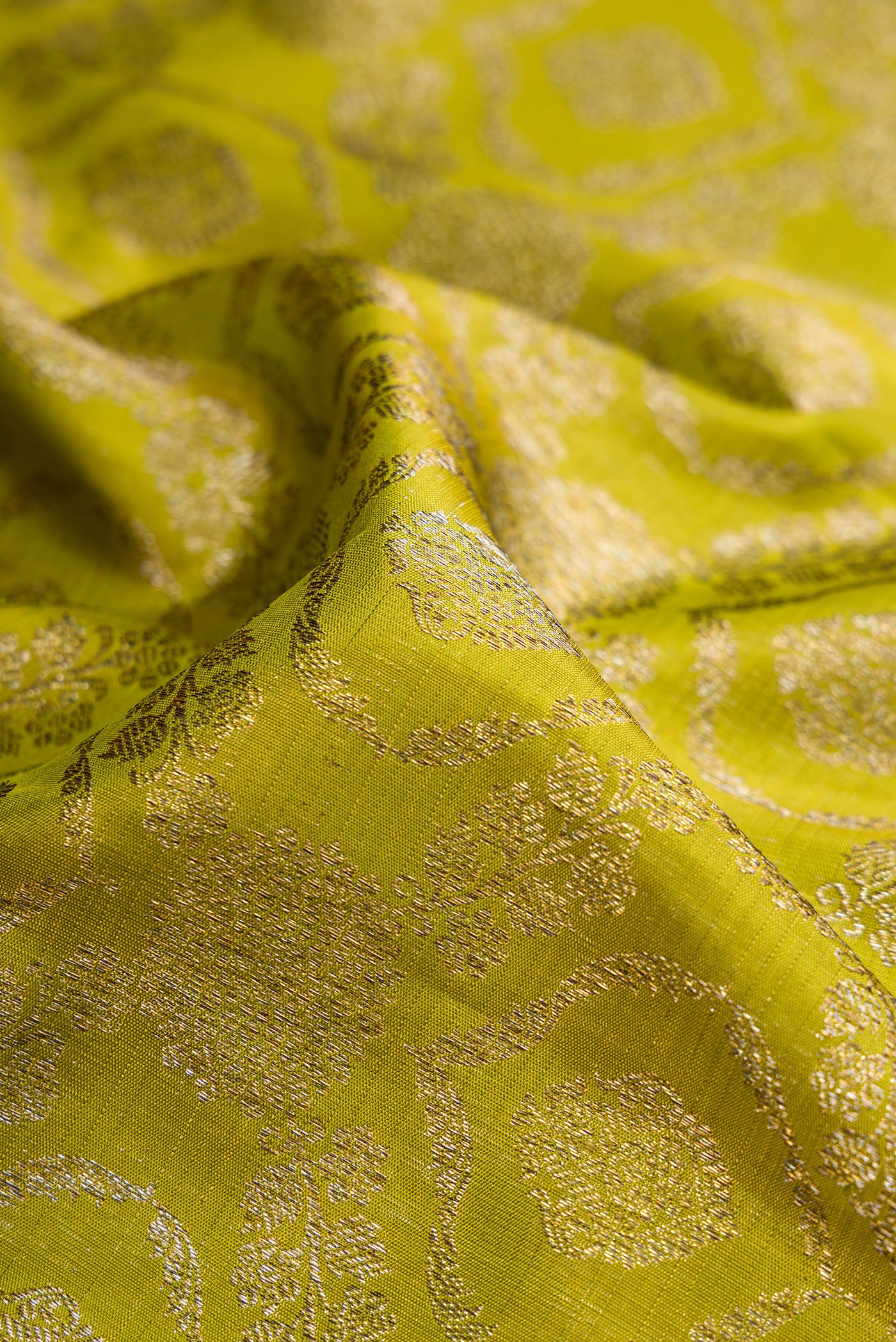 Close up of Mehandi Green Dual Tone Kanchipuram Silk Saree with Zari Brocade on the body and Zari Border.  displaying folds
