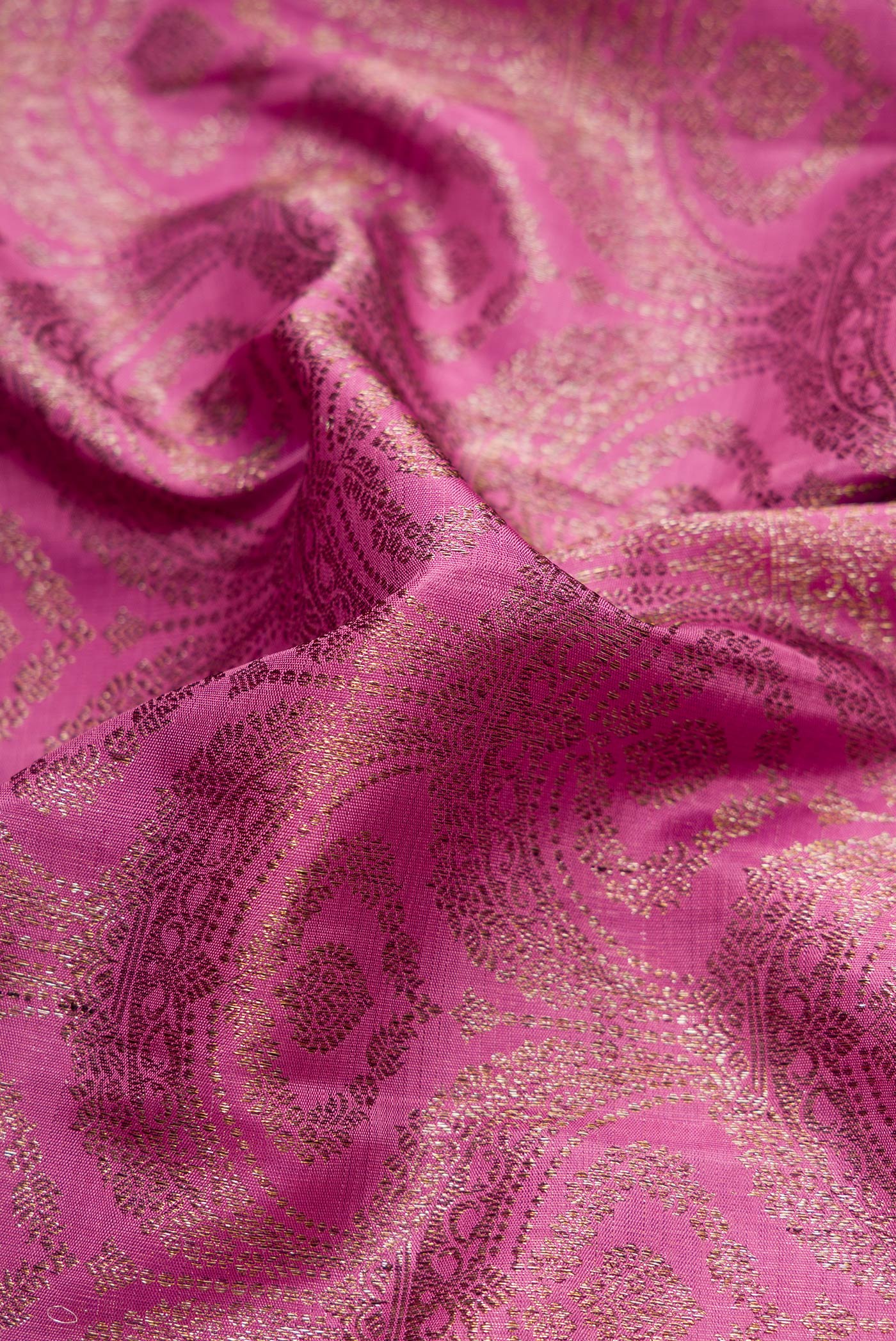Close up of Pink Dual Tone Kanchipuram Silk Saree with Zari Brocade on the body and Zari Border.  displaying folds