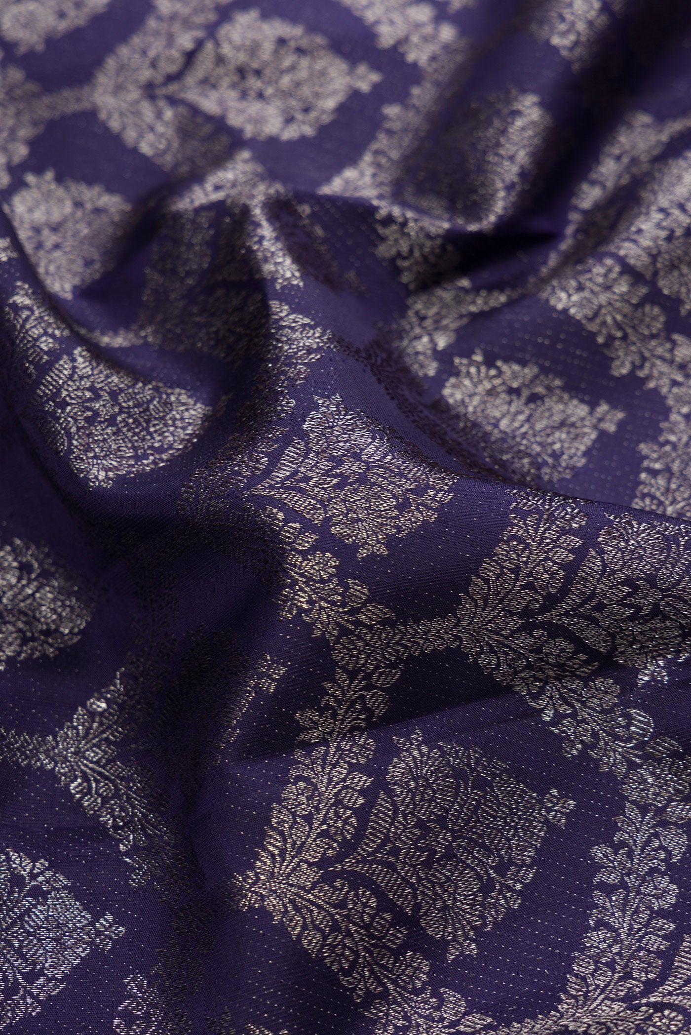 Close up of Navy Blue Dual Tone Kanjivaram Silk Saree with Zari Brocade on the body and Zari Border.  displaying folds