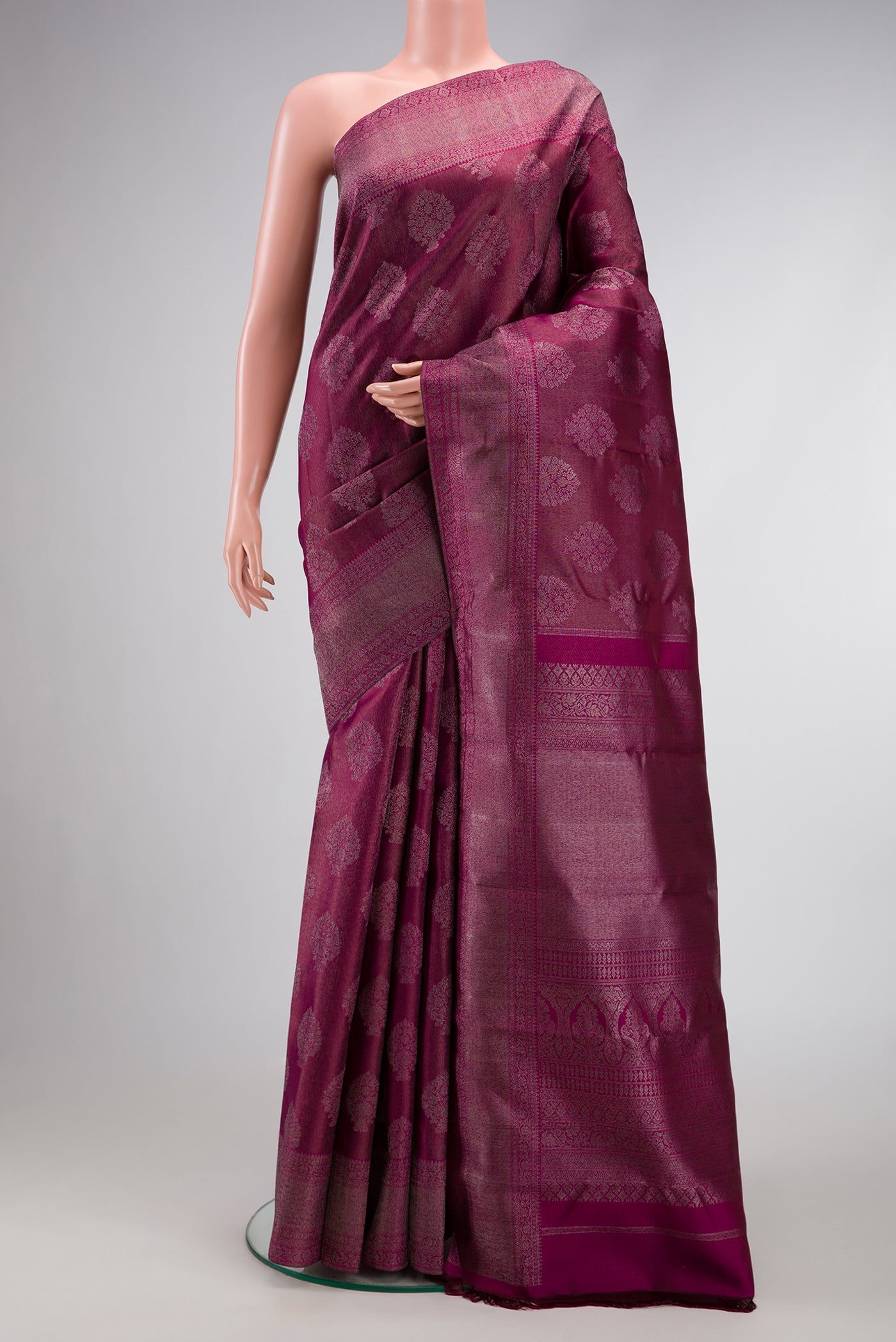 Magenta Dual Tone Kanjivaram Silk Saree with Zari Brocade on the body and Zari Border.  displayed on a mannequin
