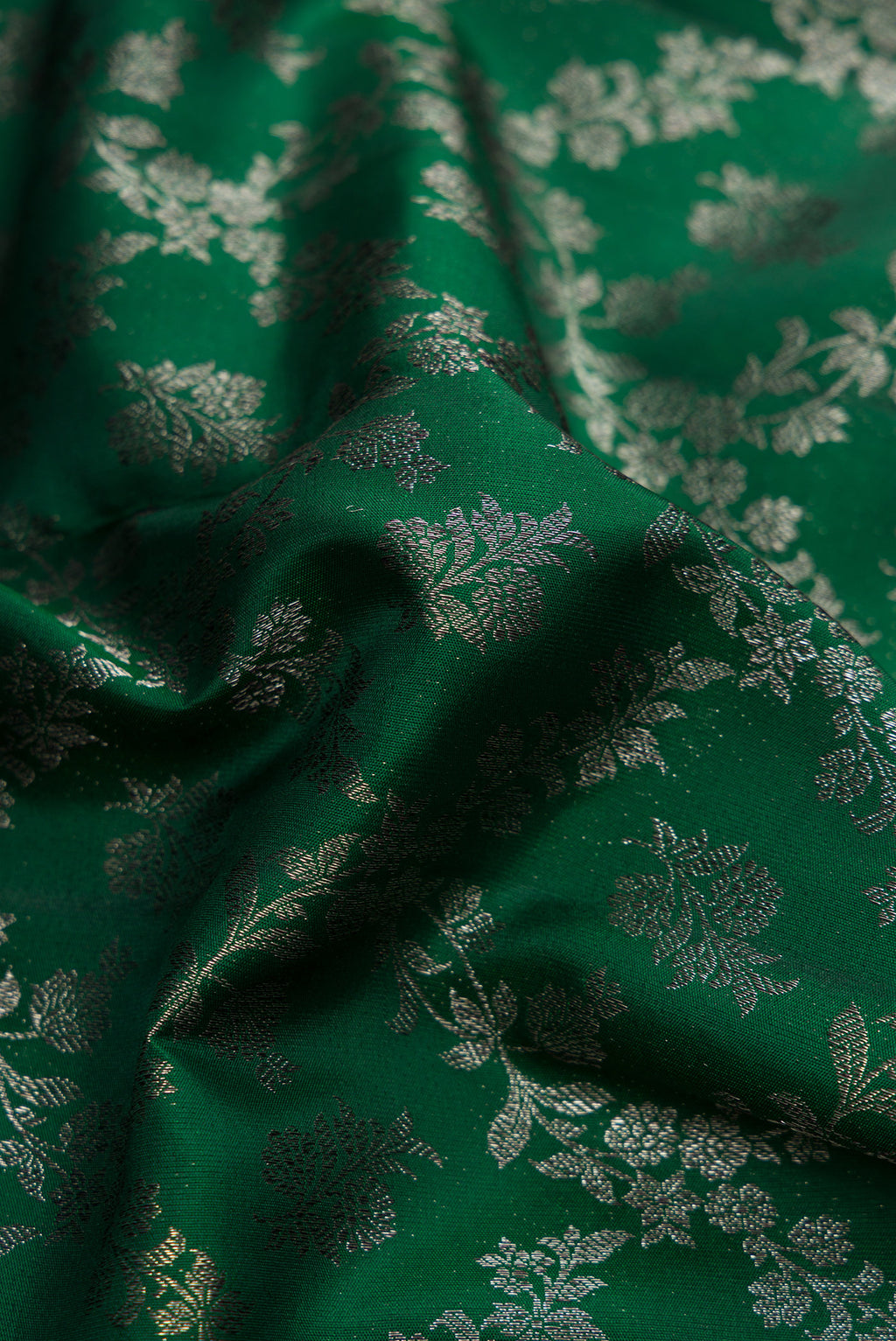 Close up of Bottle Green Dual Tone Kanjivaram Silk Saree with Zari Brocade on the body and Zari Border.  displaying folds