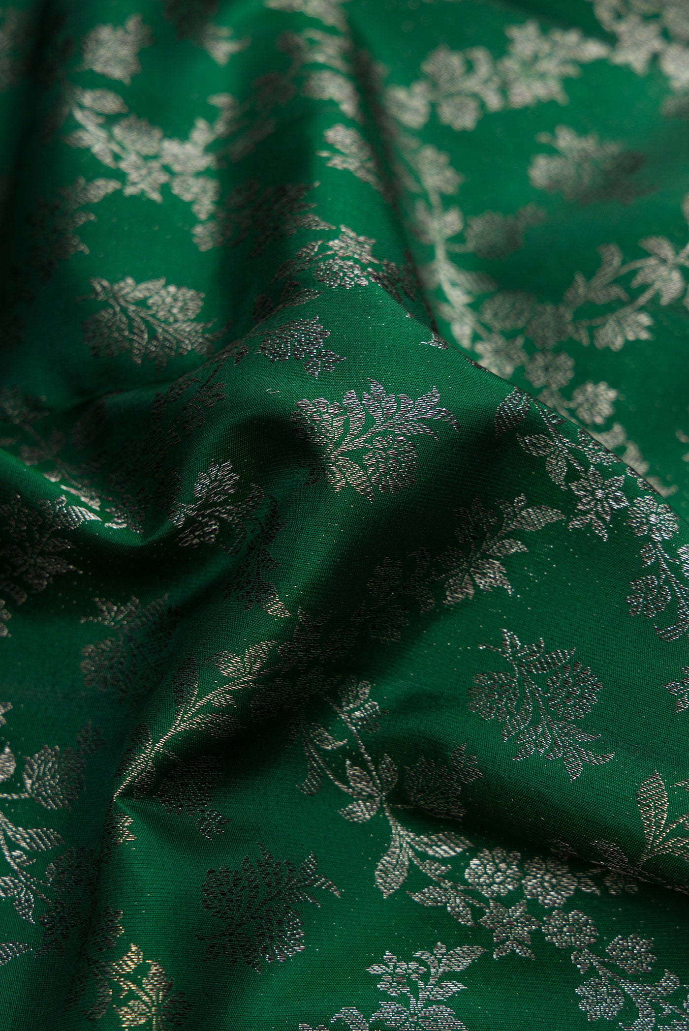 Close up of Bottle Green Dual Tone Kanjivaram Silk Saree with Zari Brocade on the body and Zari Border.  displaying folds
