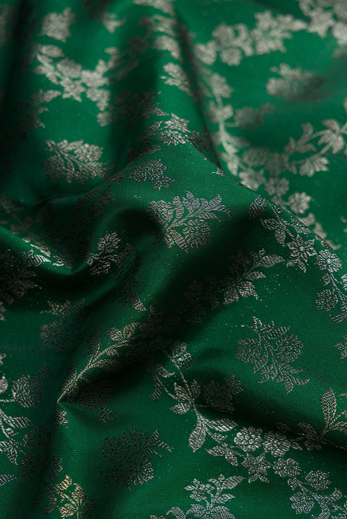 Close up of Bottle Green Dual Tone Kanjivaram Silk Saree with Zari Brocade on the body and Zari Border.  displaying folds