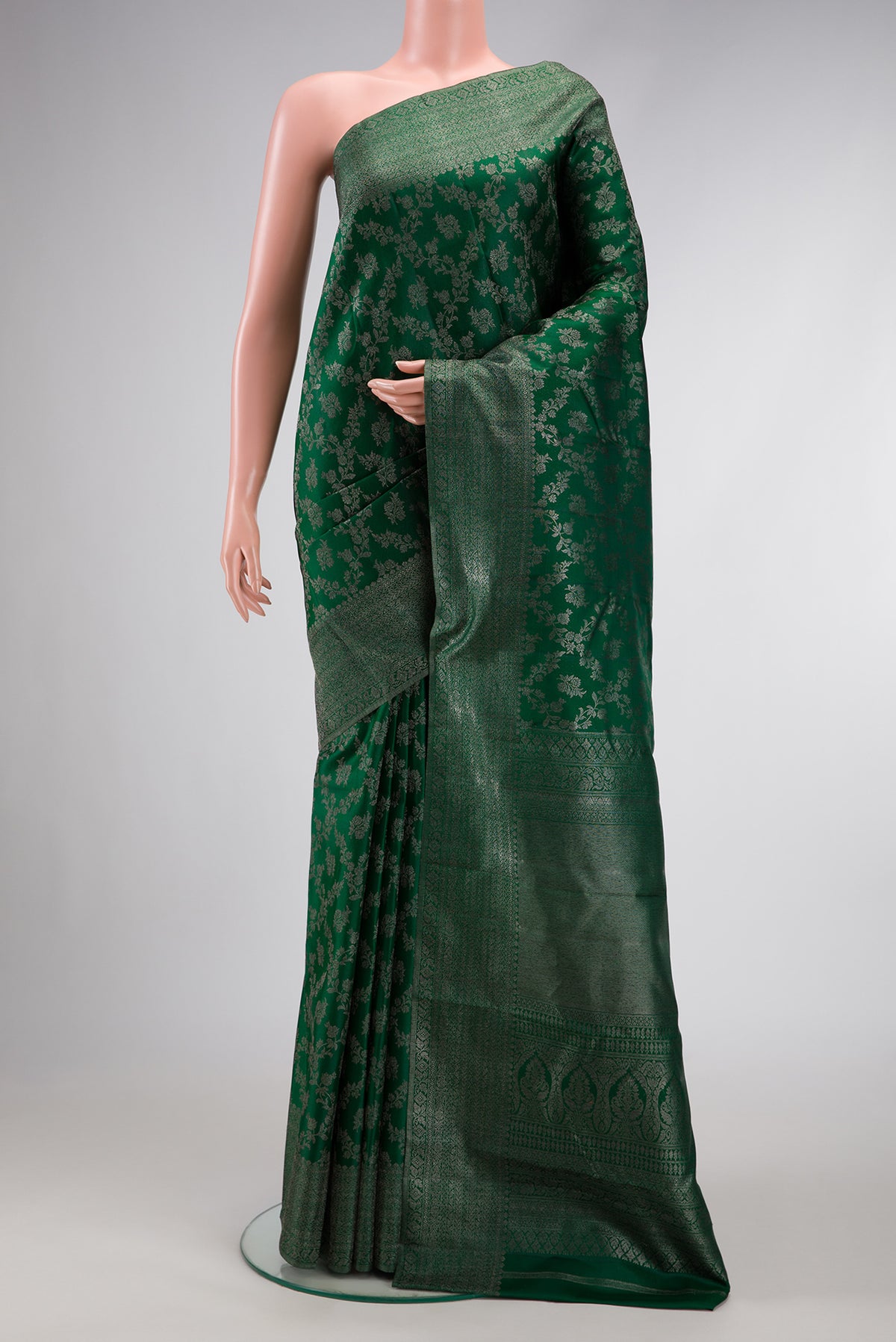 Bottle Green Dual Tone Kanjivaram Silk Saree with Zari Brocade on the body and Zari Border.  displayed on a mannequin