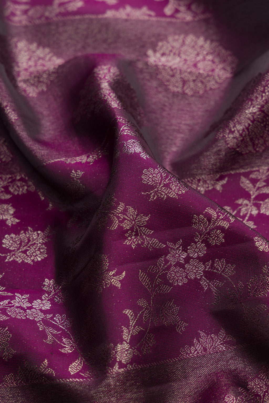 Close up of Burgundy Dual Tone Kanjivaram Silk Saree with Zari Brocade on the body and Zari Border.  displaying folds